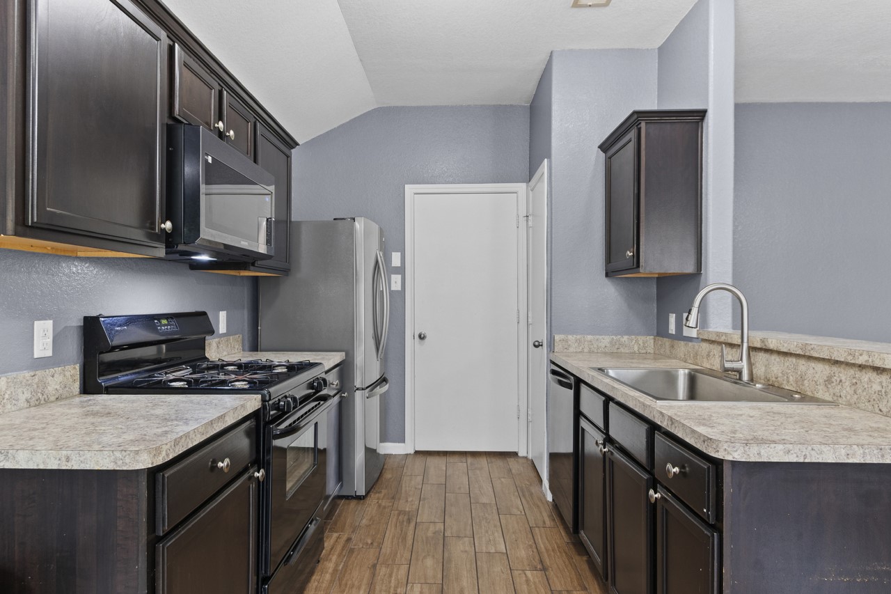 Kitchen with Full Pantry. Door goes to Laundry Room then into Garage