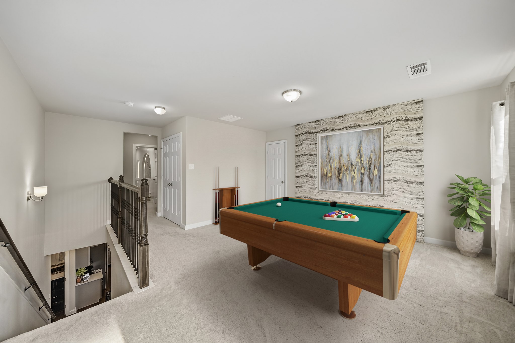 Virtually Staged: This flexible space is perfect for family fun, entertaining guests, or creating a dedicated media and recreation area. This spacious upstairs game room offers a versatile retreat designed for entertainment and relaxation. Plush carpeting, abundant natural light, and a striking accent wall create an inviting atmosphere, while the open layout provides plenty of room for a pool table, gaming area, or additional lounge seating.
