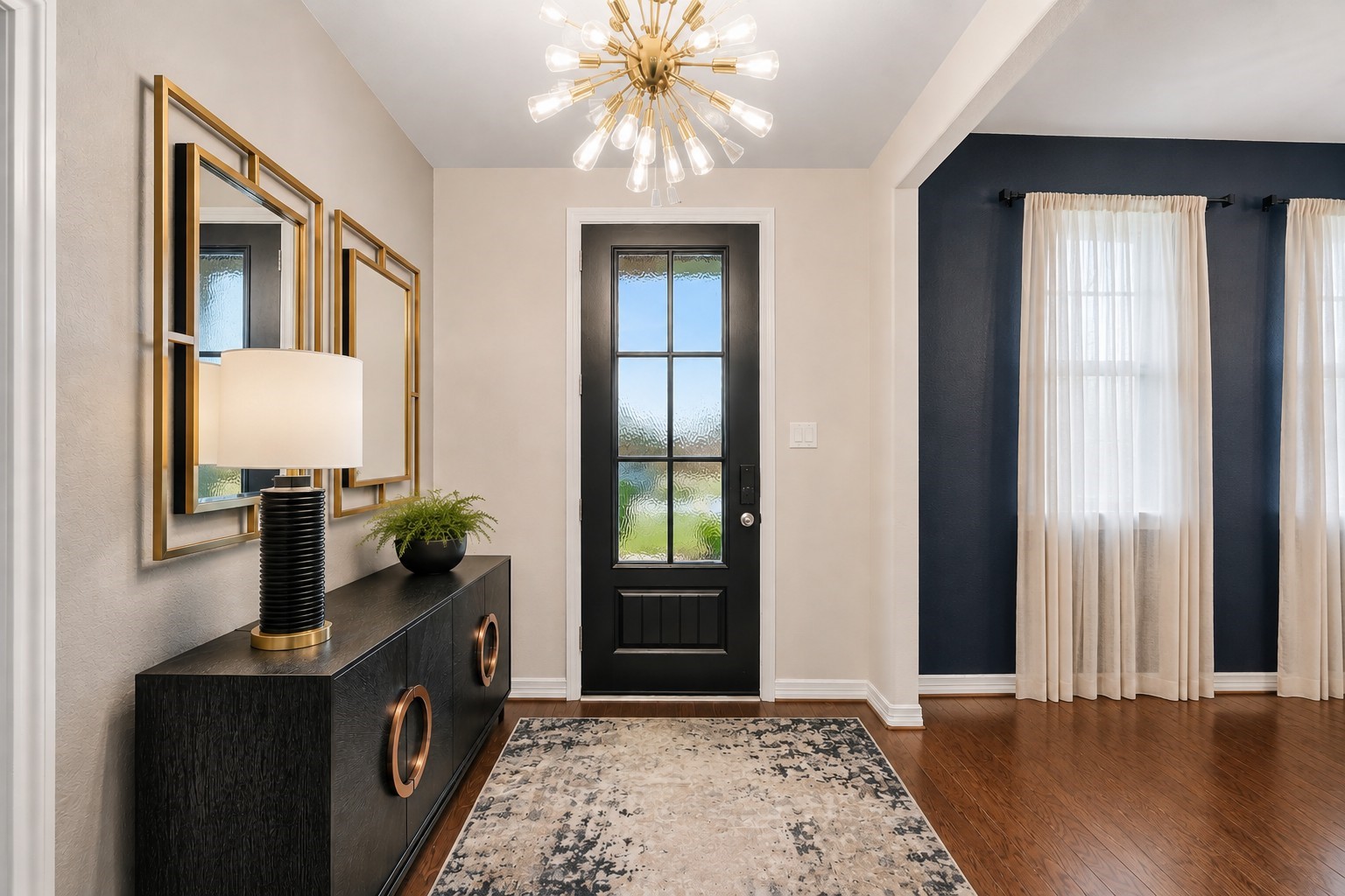 A glass-paneled front door and sophisticated contemporary finishes add character to the space.