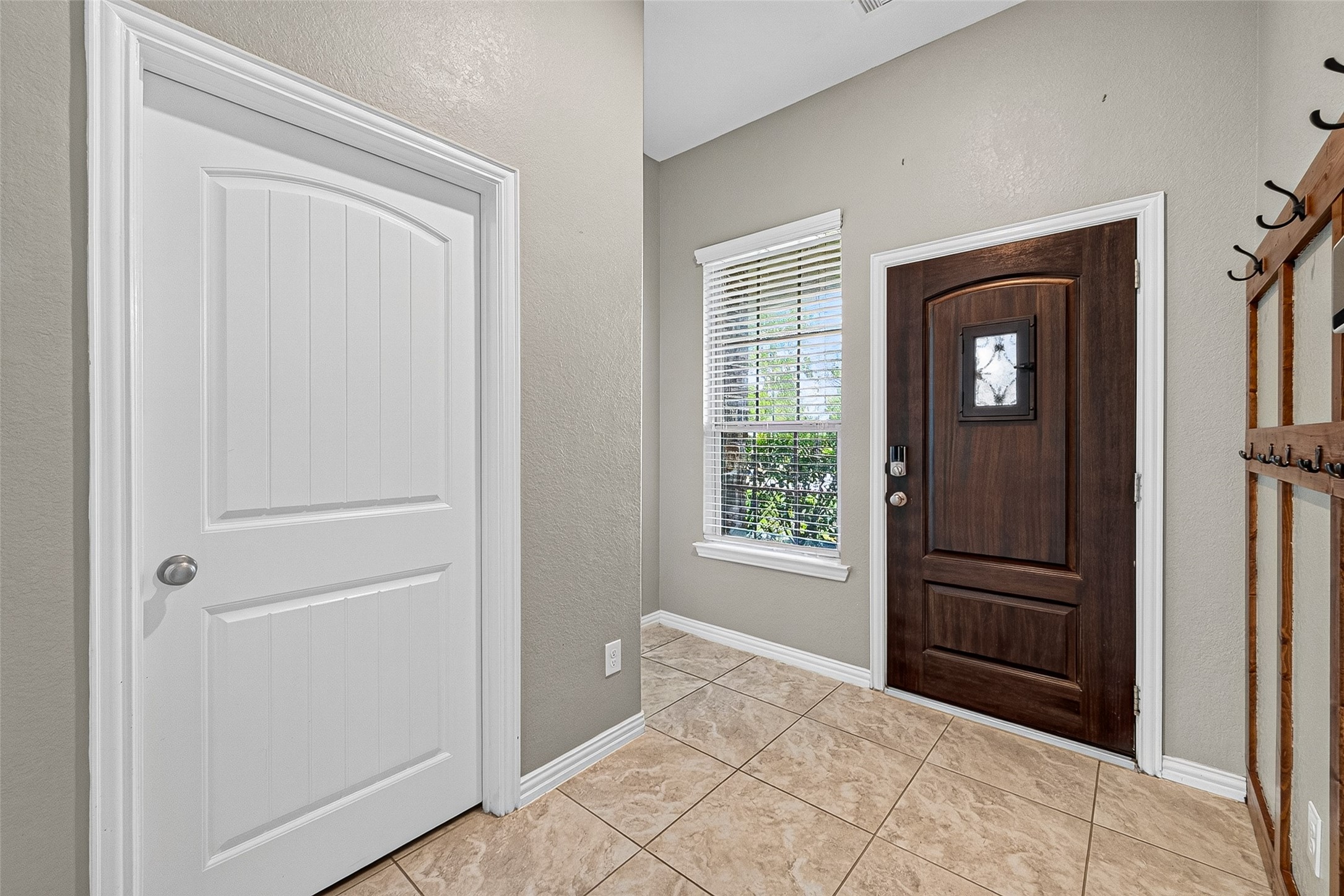 Front Entry, Left door is washer/dryer room. small hall left of window leads to guest bath.