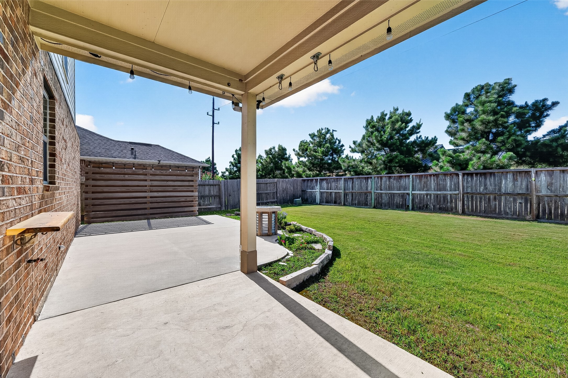 extended back patio with a privacy fence