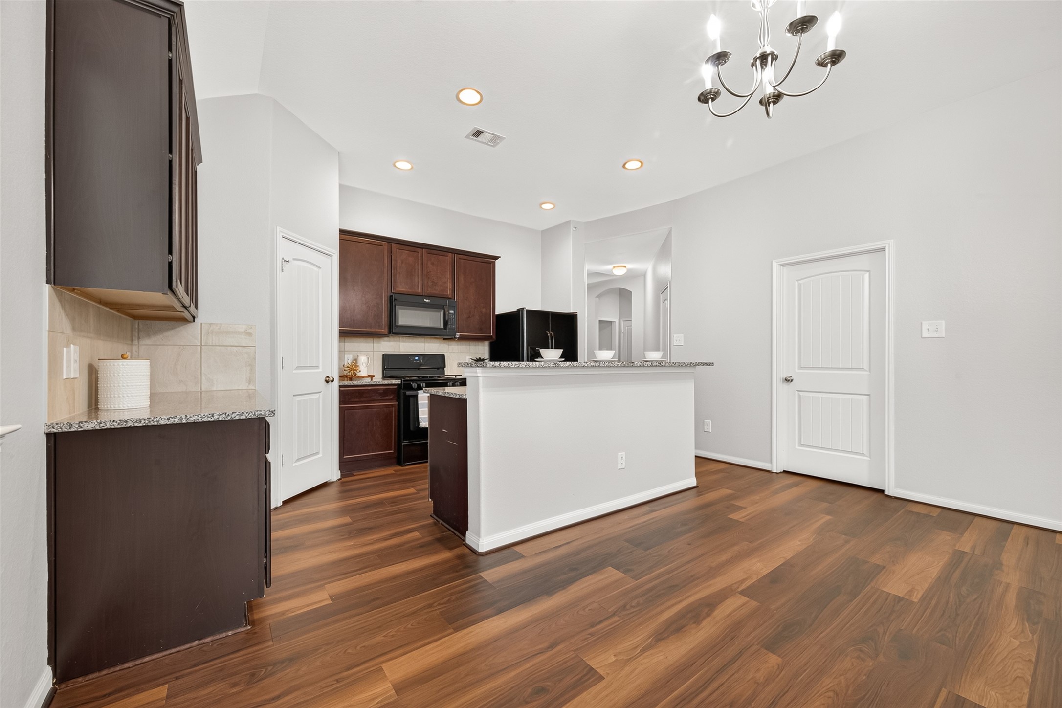 The Kitchen features beautiful granite countertops and a coordinating tile backsplash for a clean, classic look.