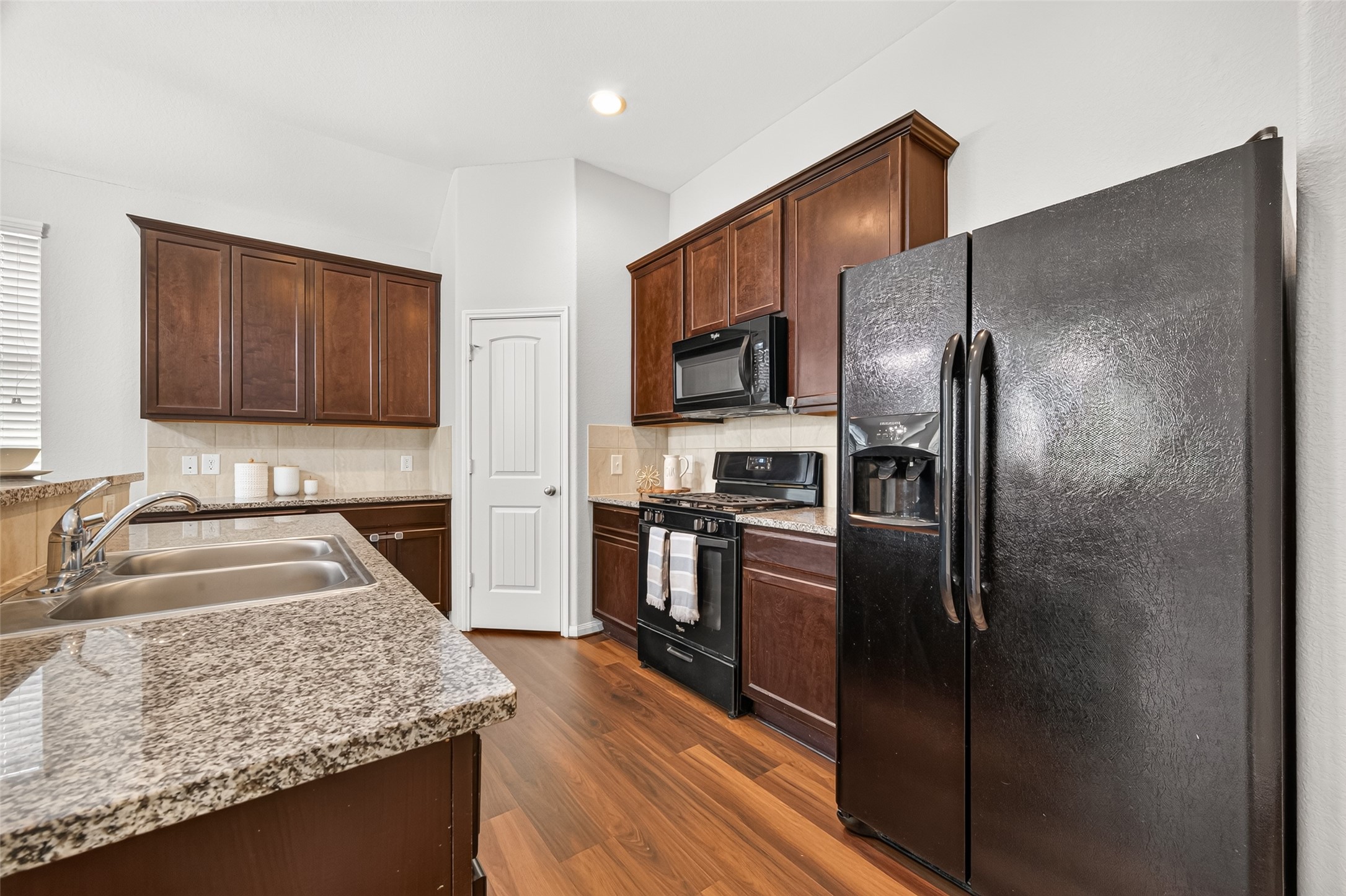 Plenty of countertop space, cabinet storage and coordinating black appliances.