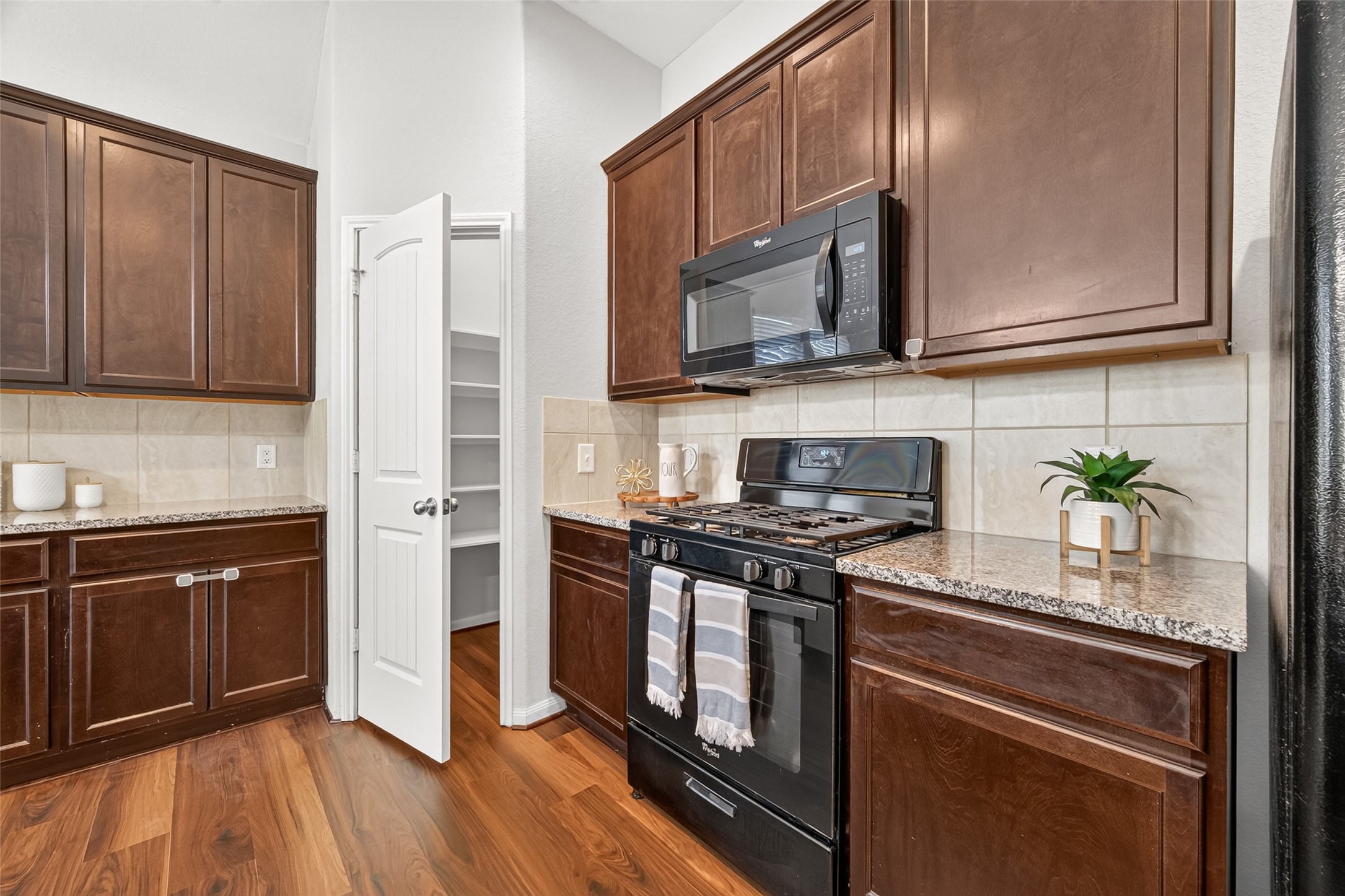 Nicely positioned in the corner of the kitchen, the walk-in pantry offers a handy spot for keeping everything organized.