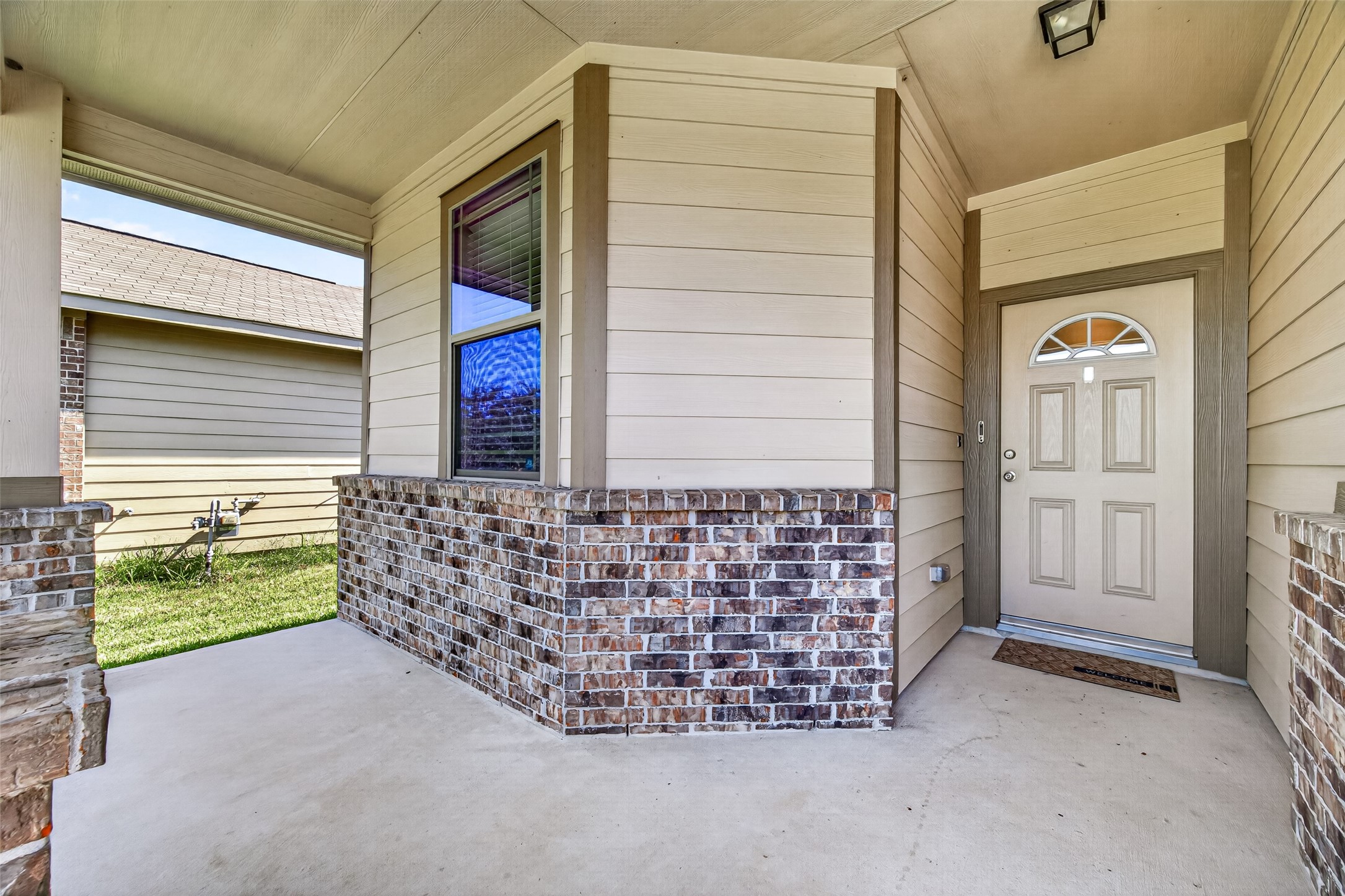 Imagine a couple of comfortable chairs and your favorite seasonal touches to make this covered front porch your own.
