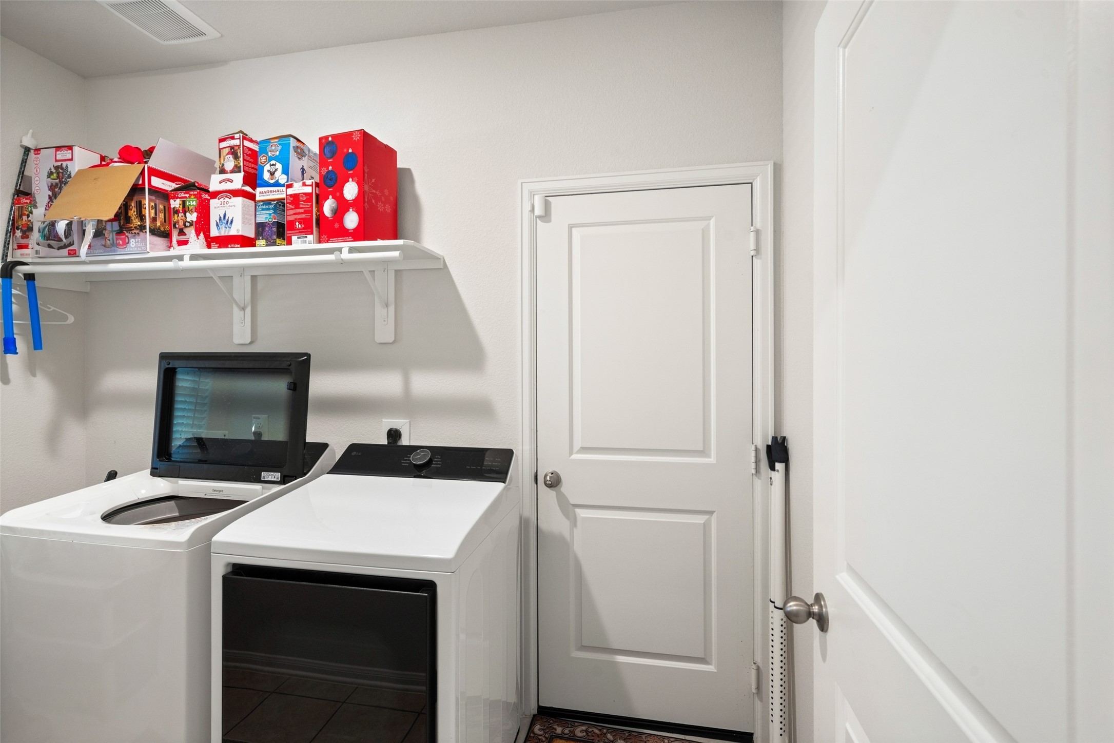 laundry room just inside front door with entry to garage