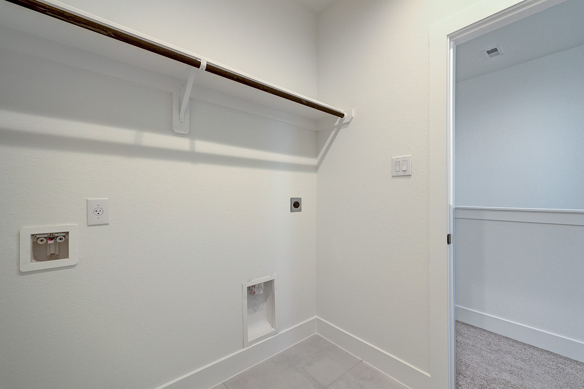 Dedicated upstairs utility room keeps laundry convenient.