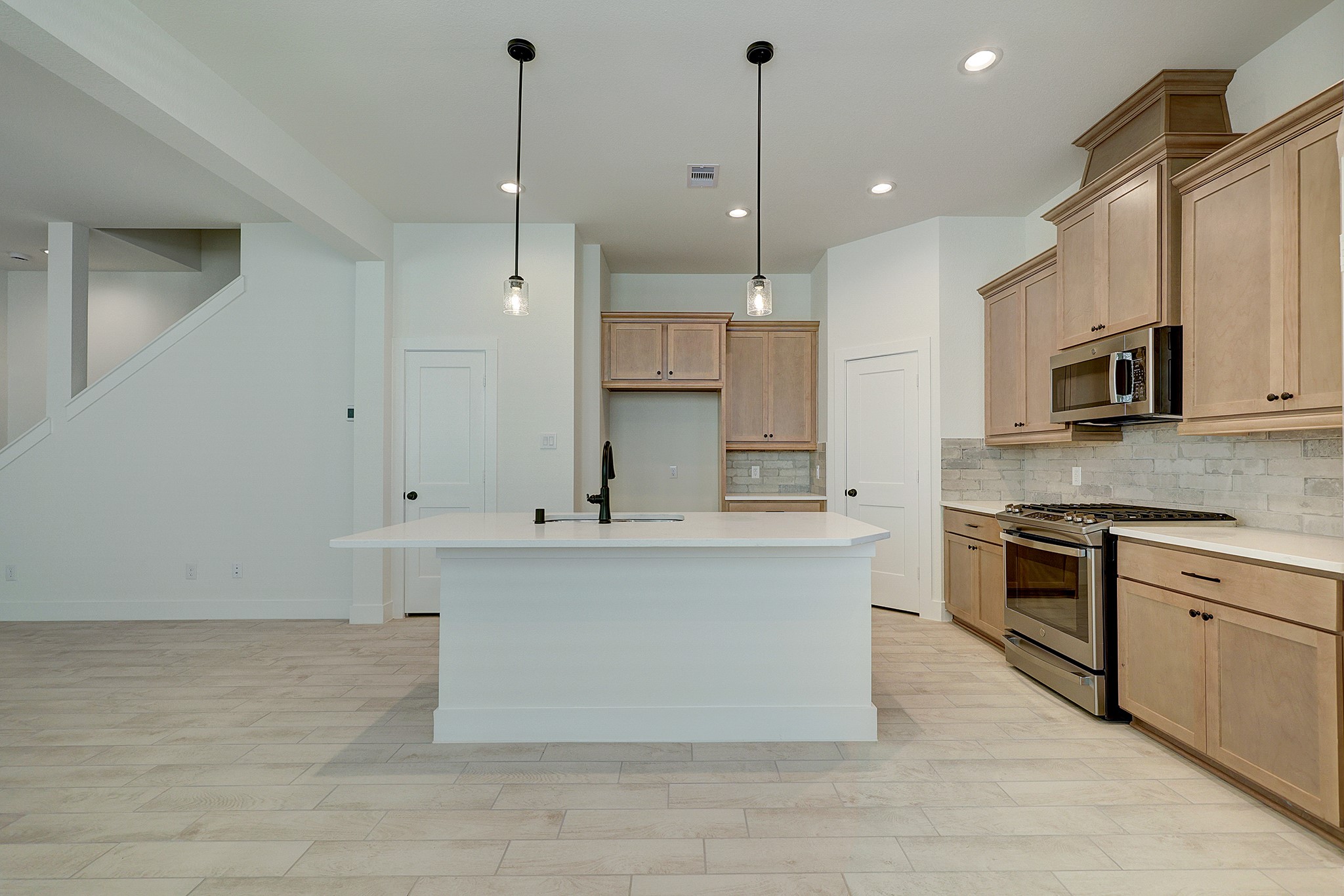 Large kitchen island creates a natural gathering space.