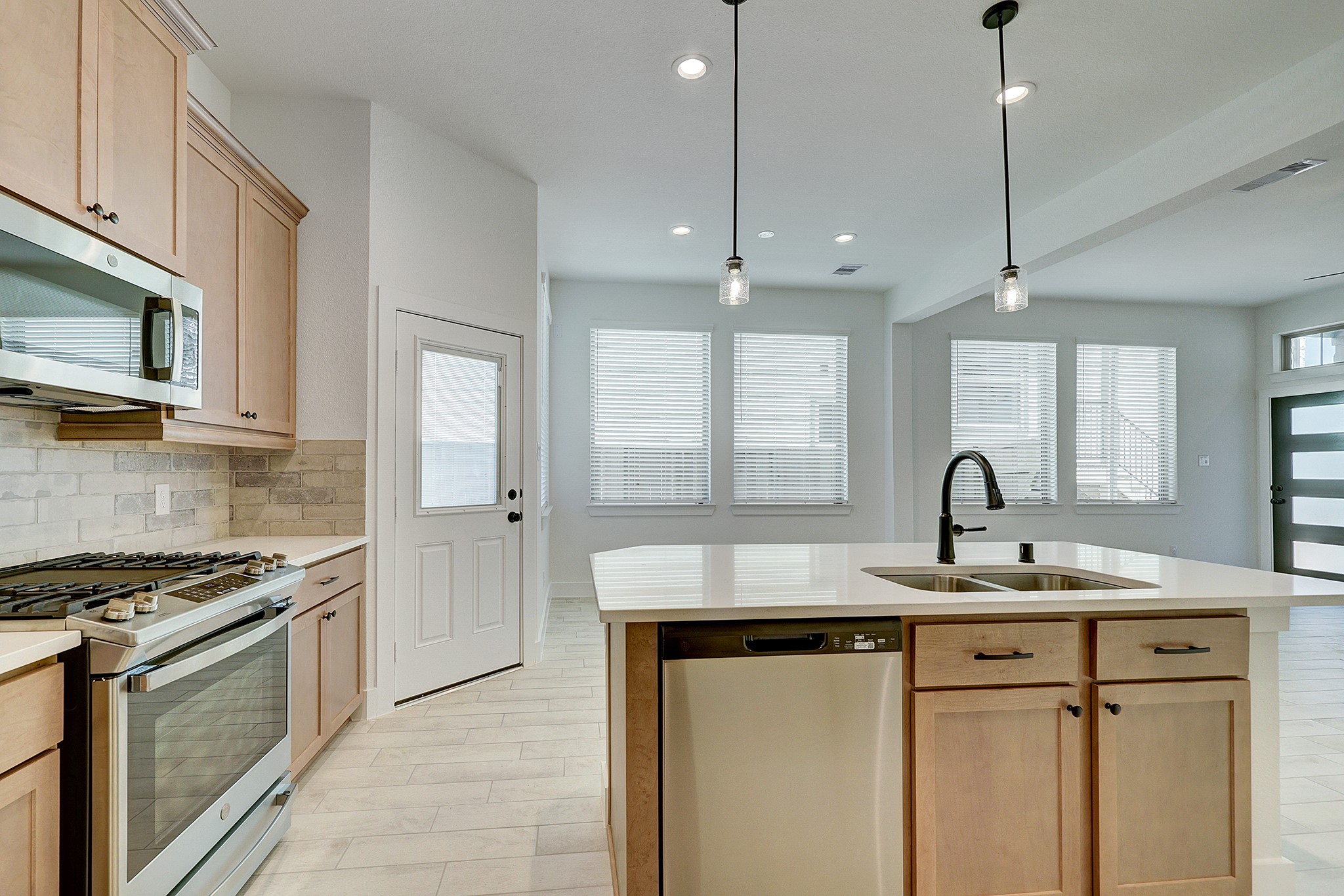Stainless appliances and abundant cabinetry complete the kitchen.