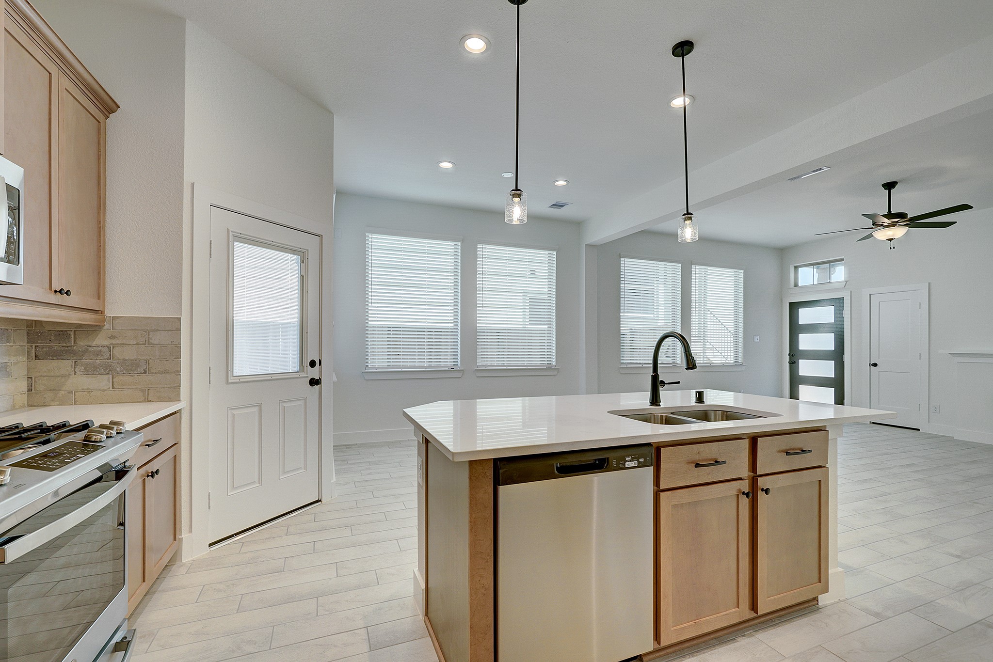Quartz island overlooks the bright, open living space.