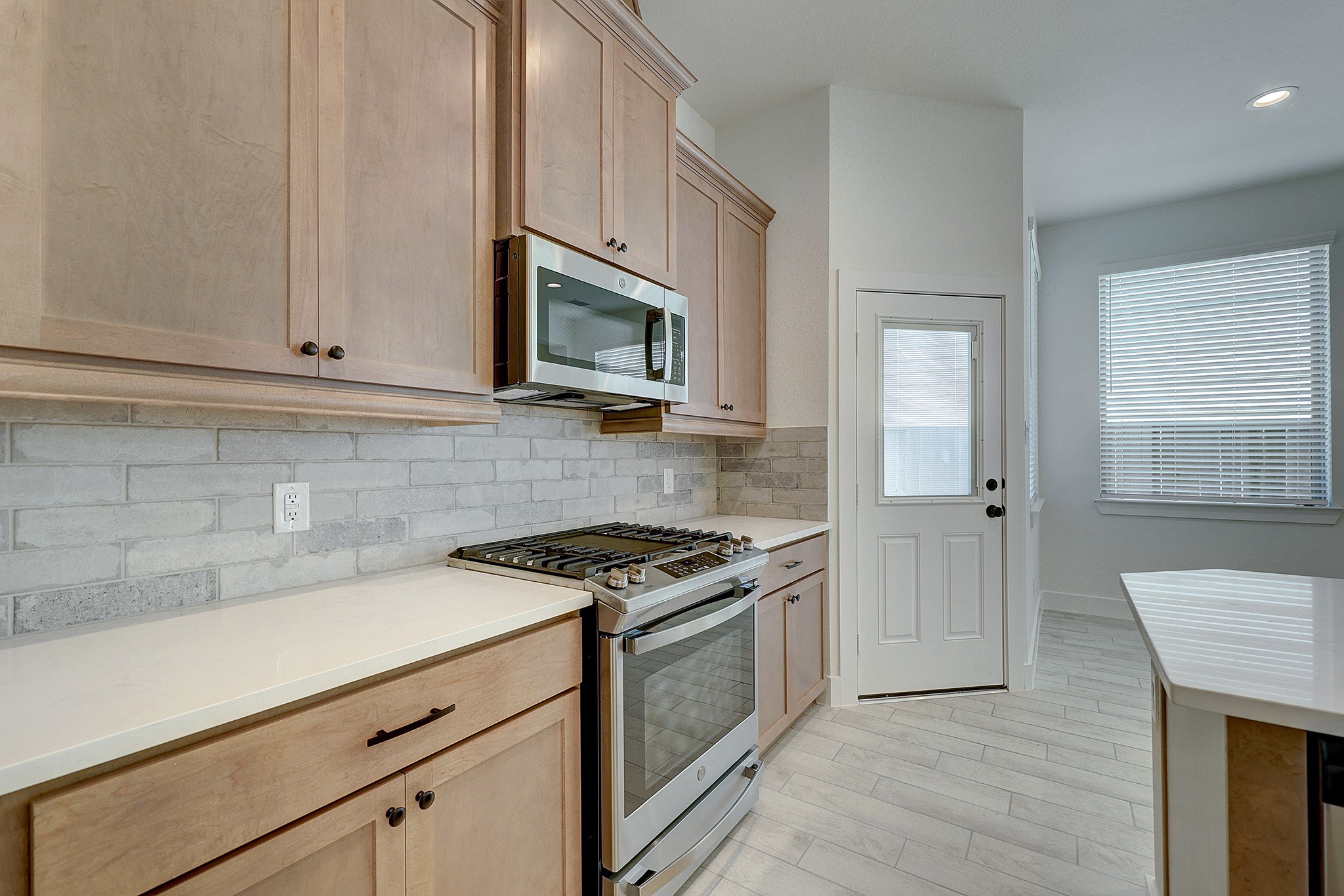 Stylish backsplash, stainless appliances and generous counter space.