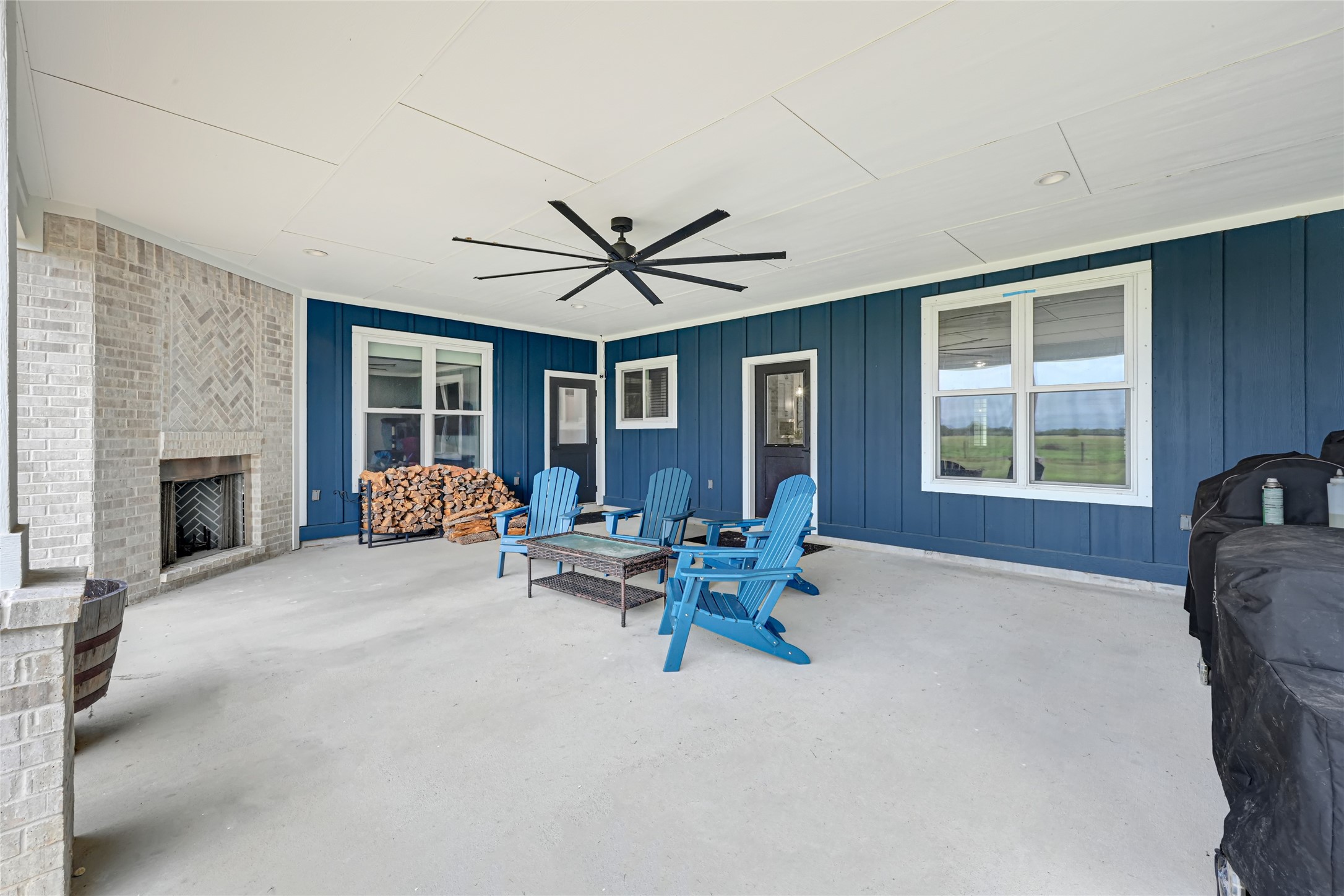 Oversized patio with ceiling fan and wood burning fireplace