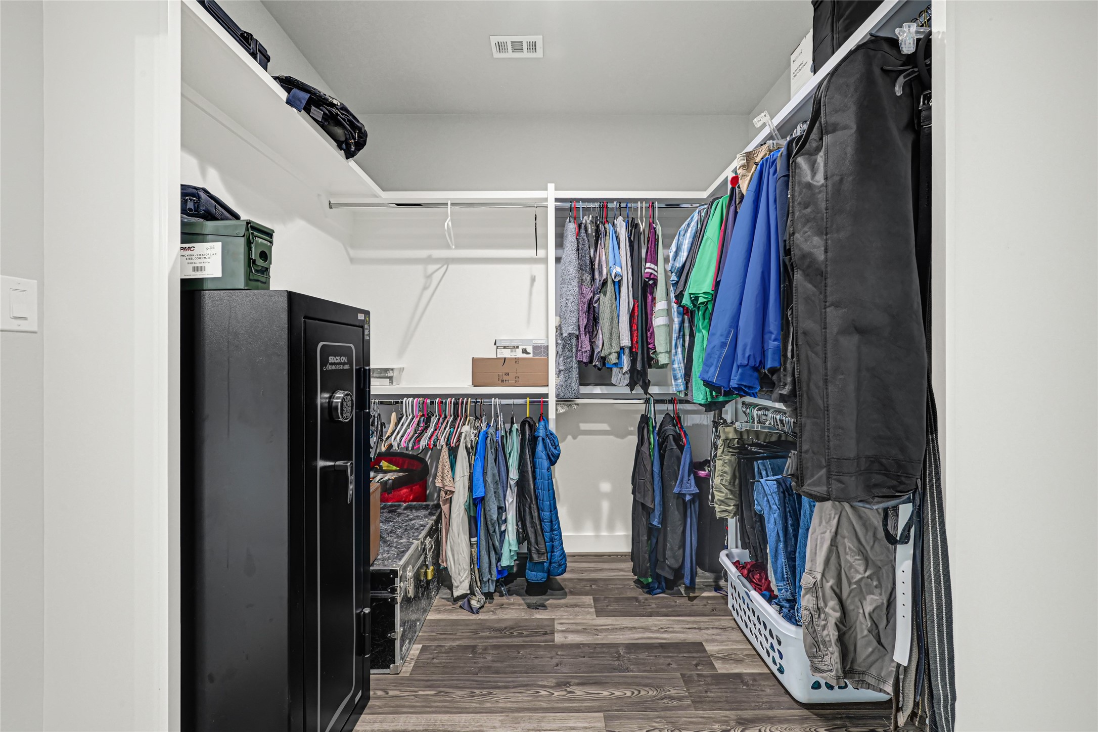 Large primary closet with access to laundry room, and doubles as a safe room