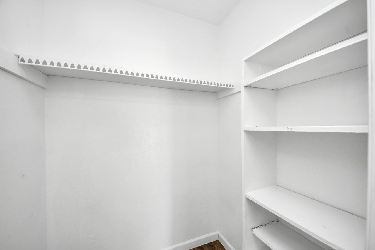 Primary Walk In Closet with built ins
