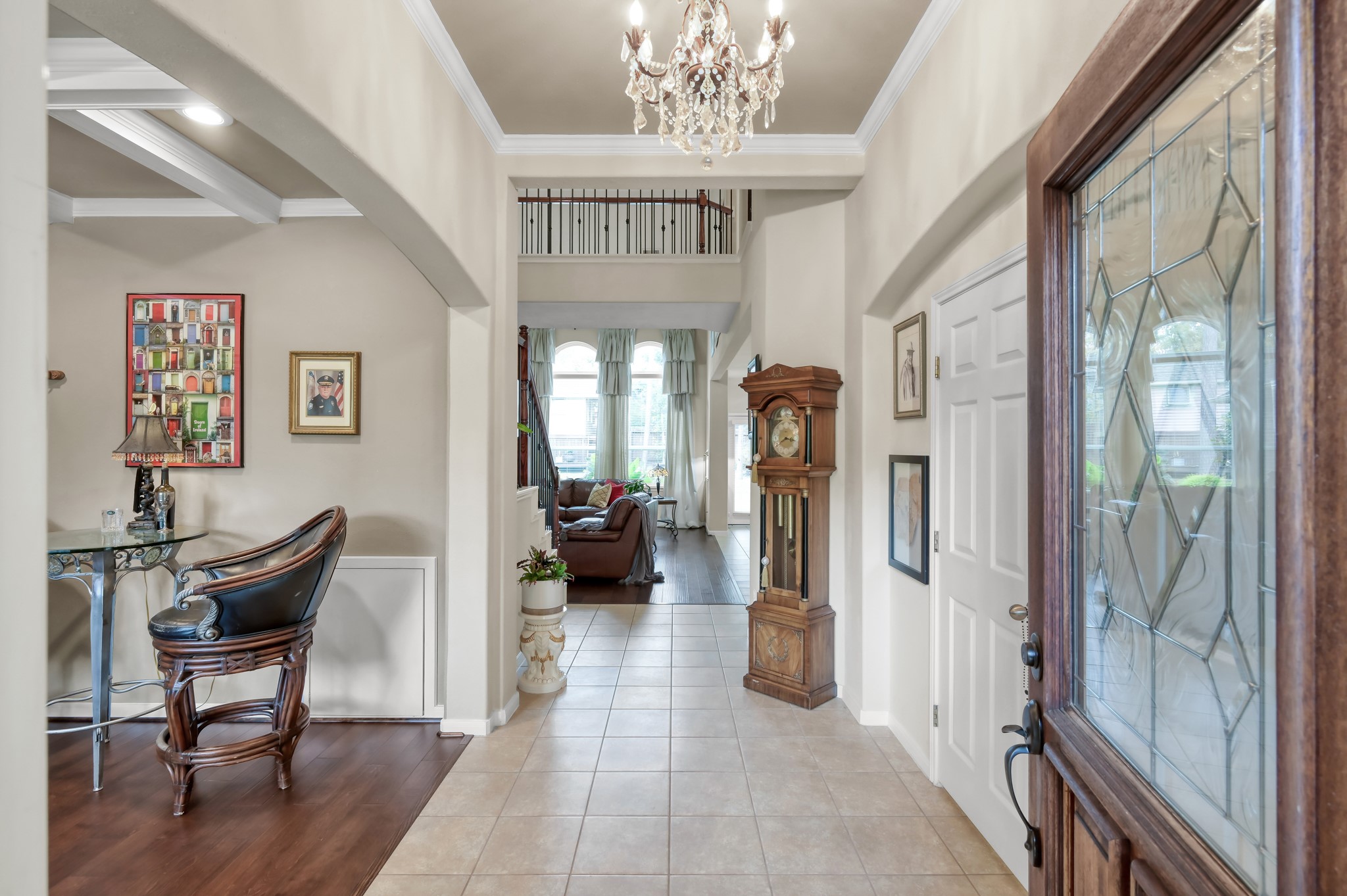 Step inside to soaring ceilings, elegant lighting, and an open, airy entryway that instantly feels welcoming. Natural light pours through the home, while the wood and tile flooring add warmth and style throughout. Step inside to soaring ceilings, elegant lighting, and an open, airy entryway that instantly feels welcoming. Natural light pours through the home, while the wood and tile flooring add warmth and style throughout.