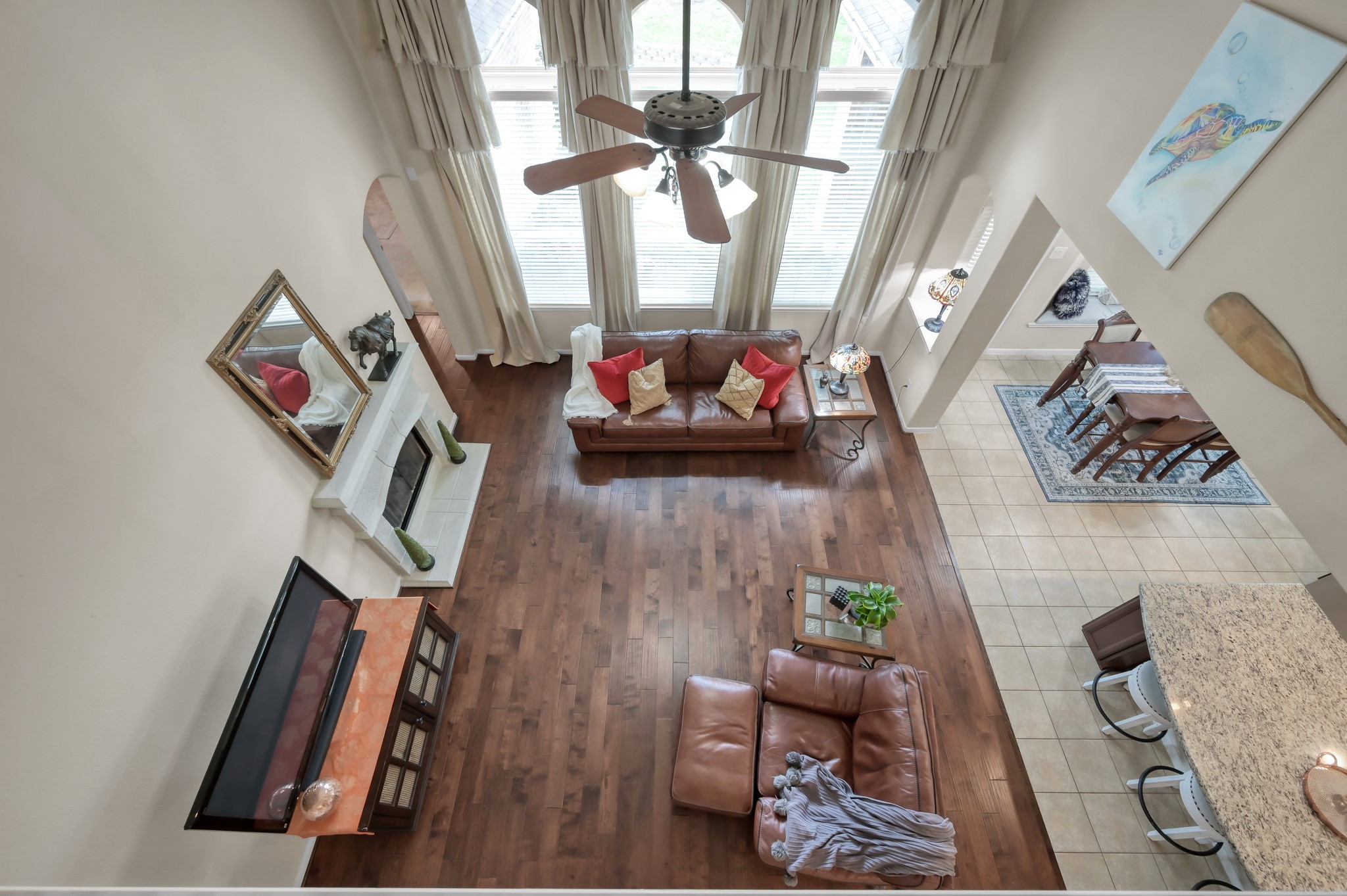 An impressive overlook from the second floor showcases the homes open layout, soaring ceilings, and abundance of natural light. The perfect design for both entertaining and comfortable everyday living.