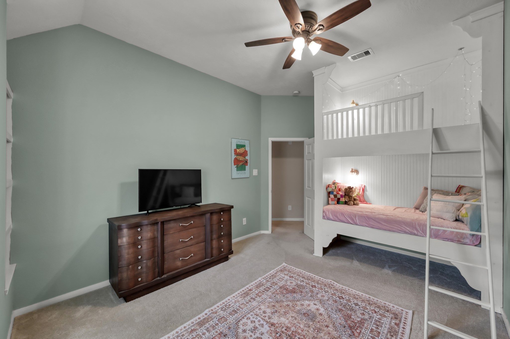 Charming bedroom with custom built-in bunk space, soft designer colors, and an open layout that makes the room both fun and functional.