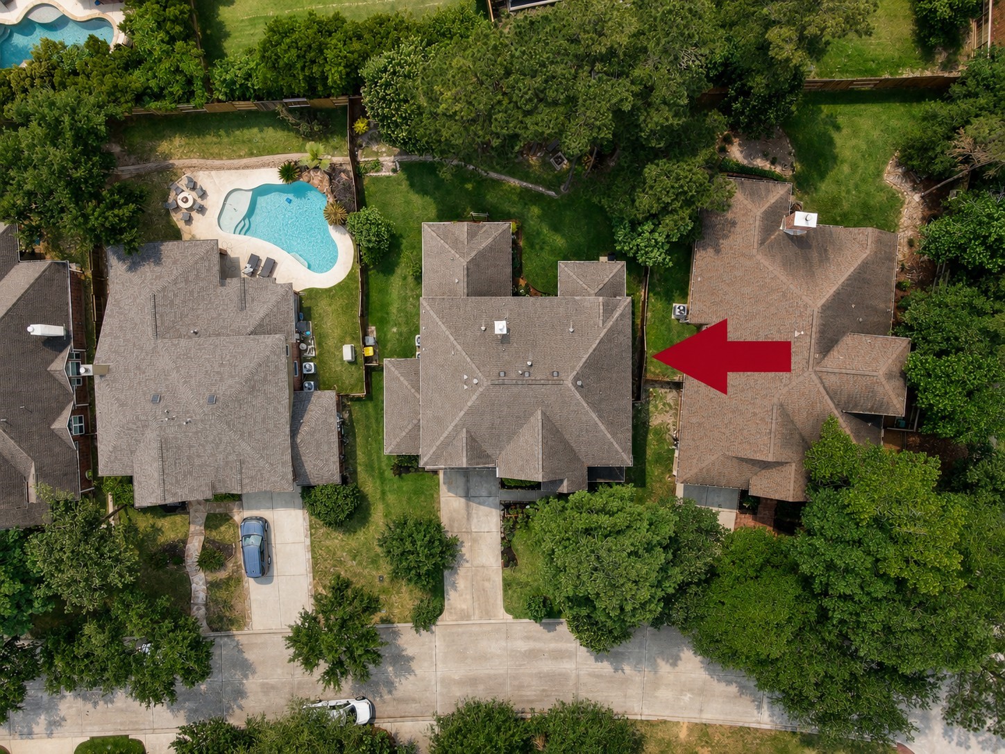 This aerial perspective showcases the homes ideal location within the neighborhood, generous outdoor space, and easy access to nearby amenities while still offering a peaceful residential feel.