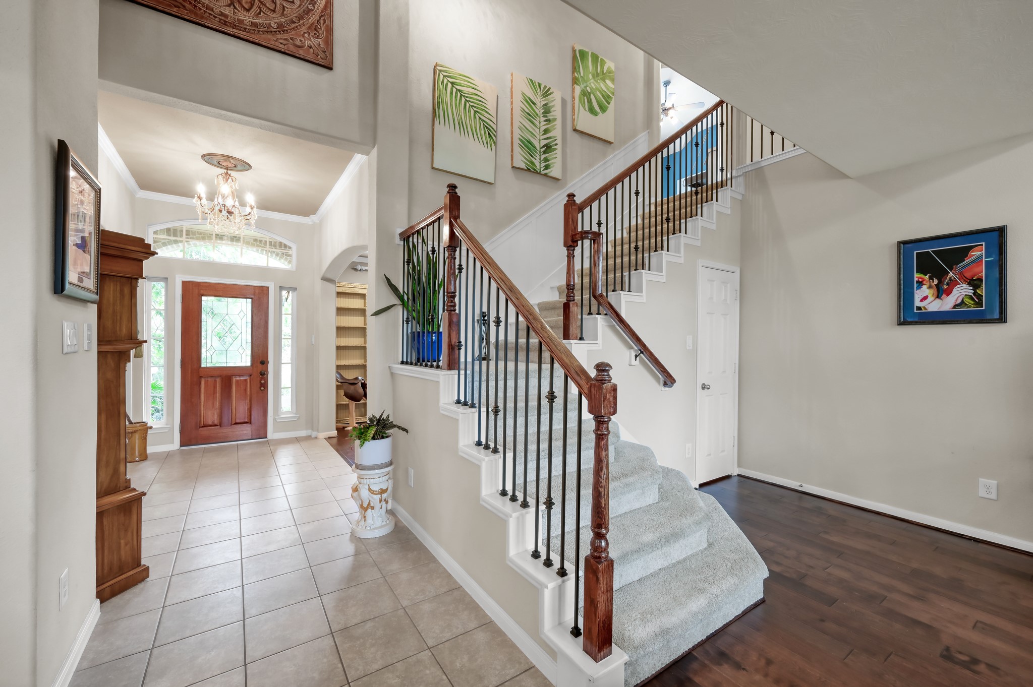 Beautiful staircase with wrought iron details and wood accents creates a grand focal point the moment you walk in. The open layout and soaring ceilings make the home feel bright and inviting. Beautiful staircase with wrought iron details and wood accents creates a grand focal point the moment you walk in. The open layout and soaring ceilings make the home feel bright and inviting.