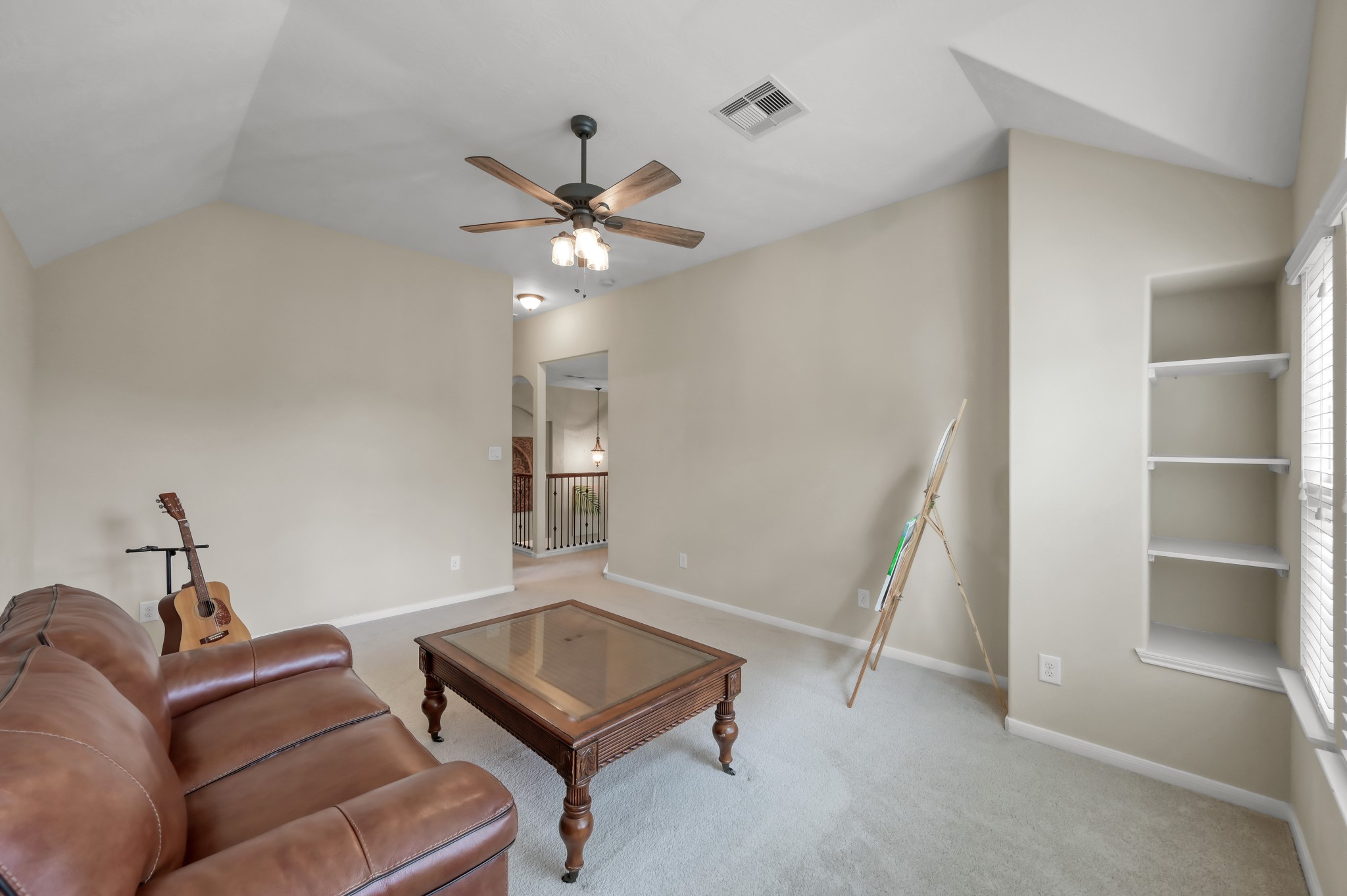 This room also offers built-in shelving and open space ideal for a playroom, hobby room, second office, or lounge area.