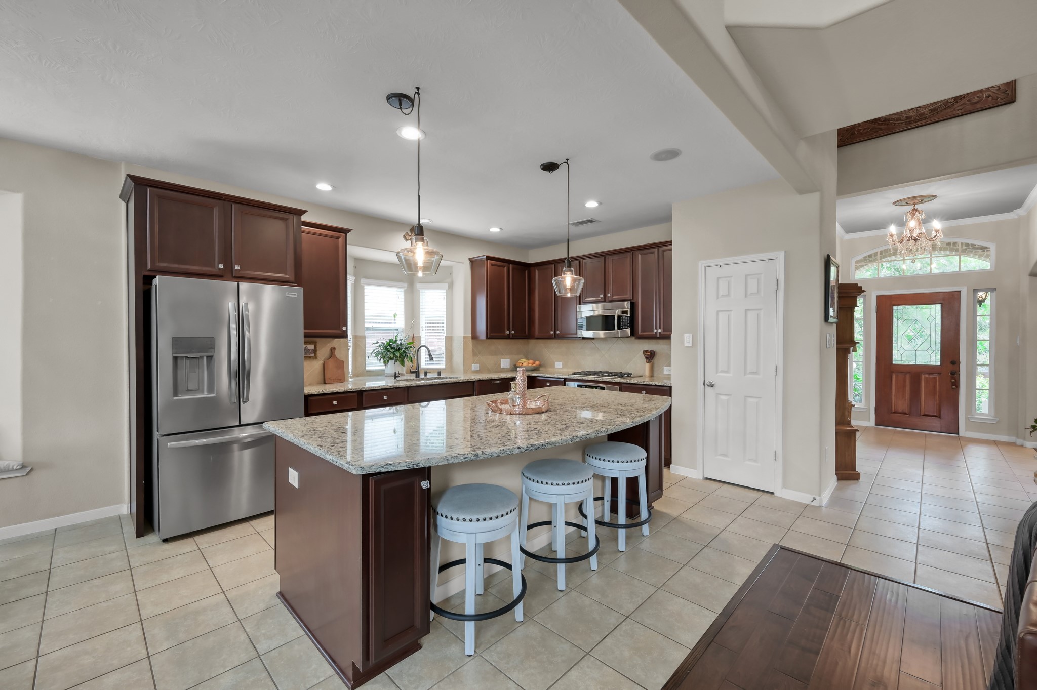 The open-concept design flows seamlessly from the kitchen into the main living areas and entryway, creating an airy feel with great sightlines throughout the home.