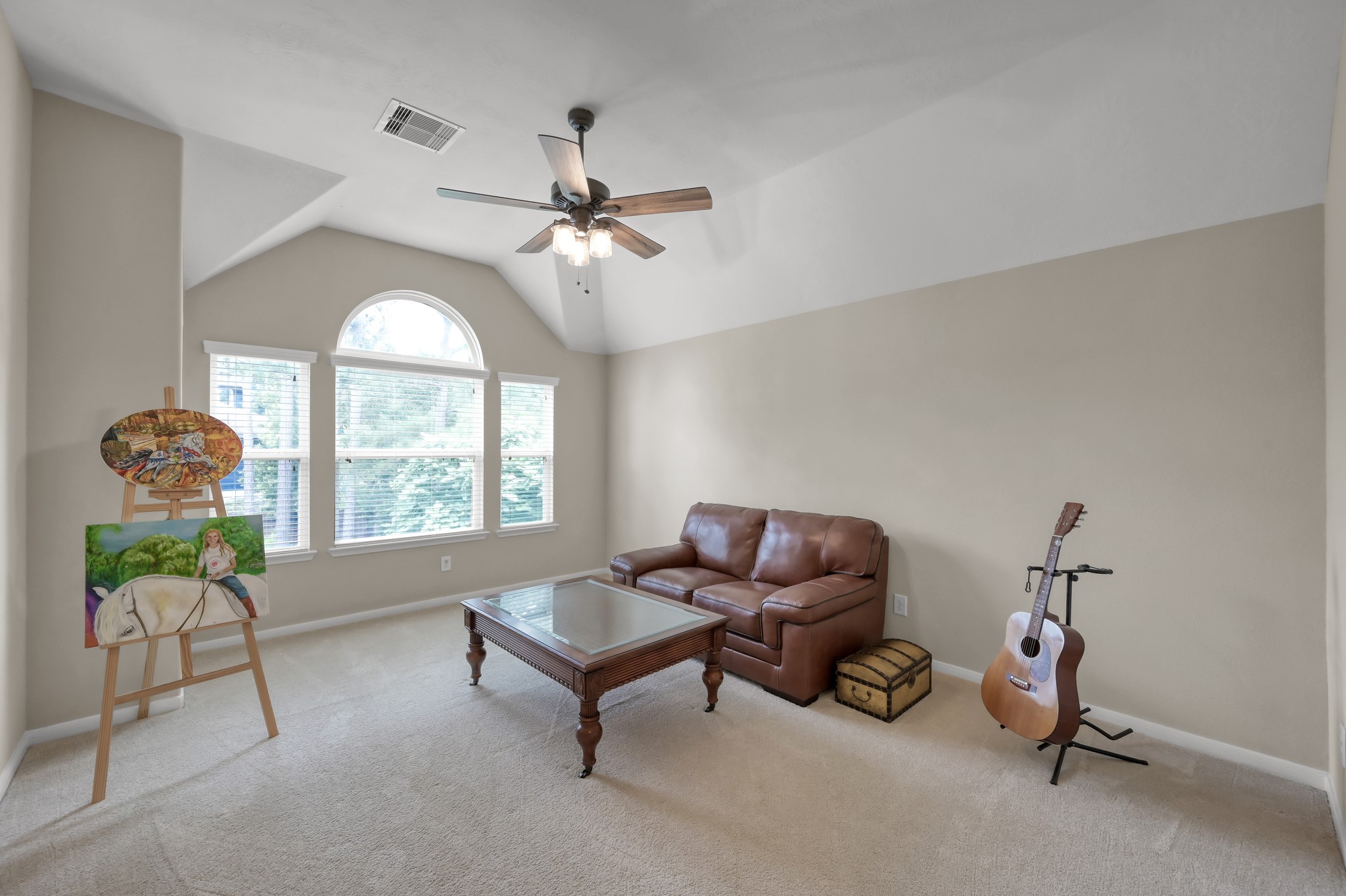 Bright and open secondary living space or game room with oversized windows and endless possibilities for relaxing, entertaining, hobbies, or creating your own personal retreat.