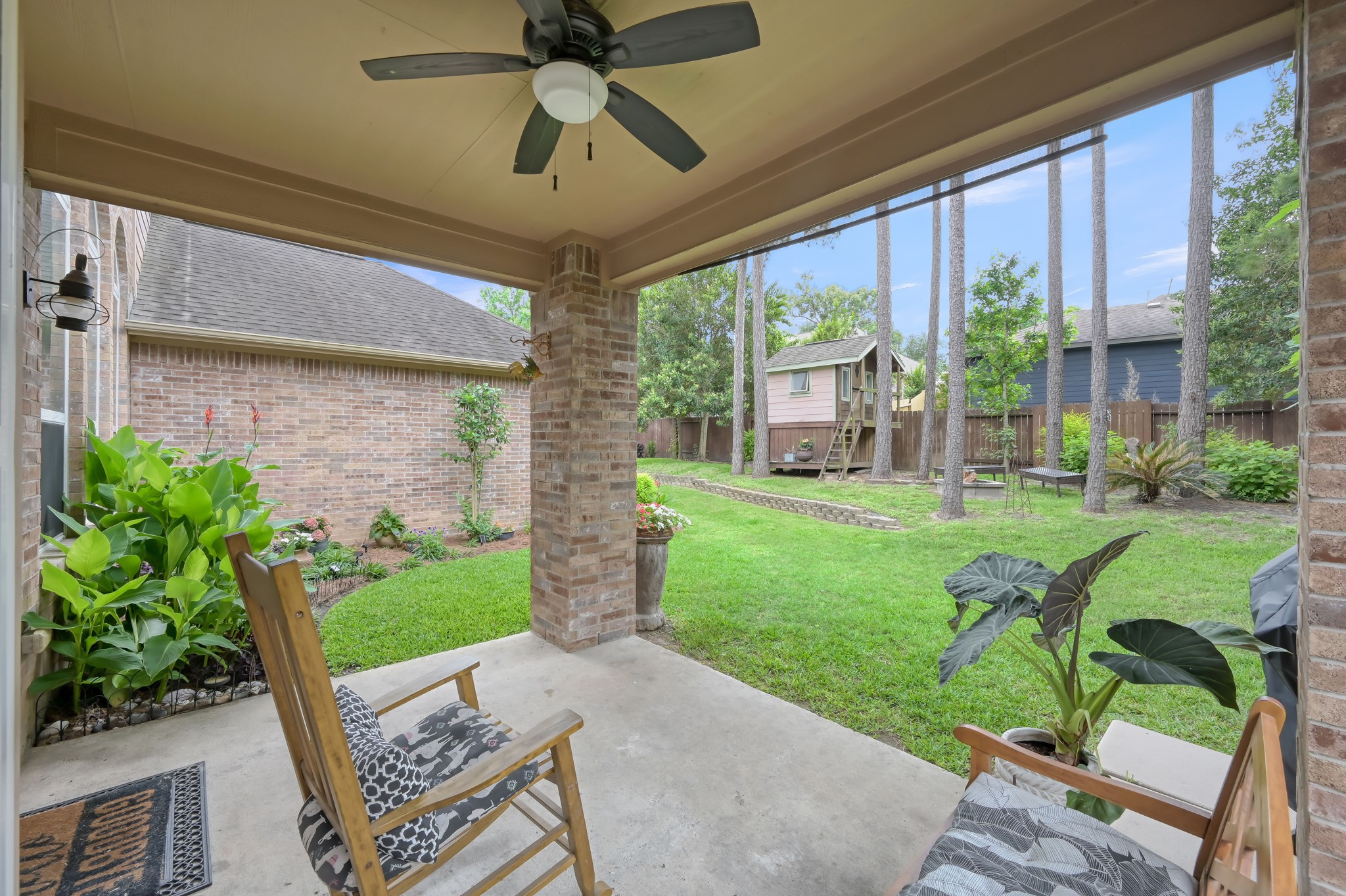 Relax and unwind on the covered back patio overlooking a lush backyard filled with towering trees and plenty of green space. Whether youre enjoying your morning coffee or hosting friends, this backyard feels private, peaceful, and inviting.