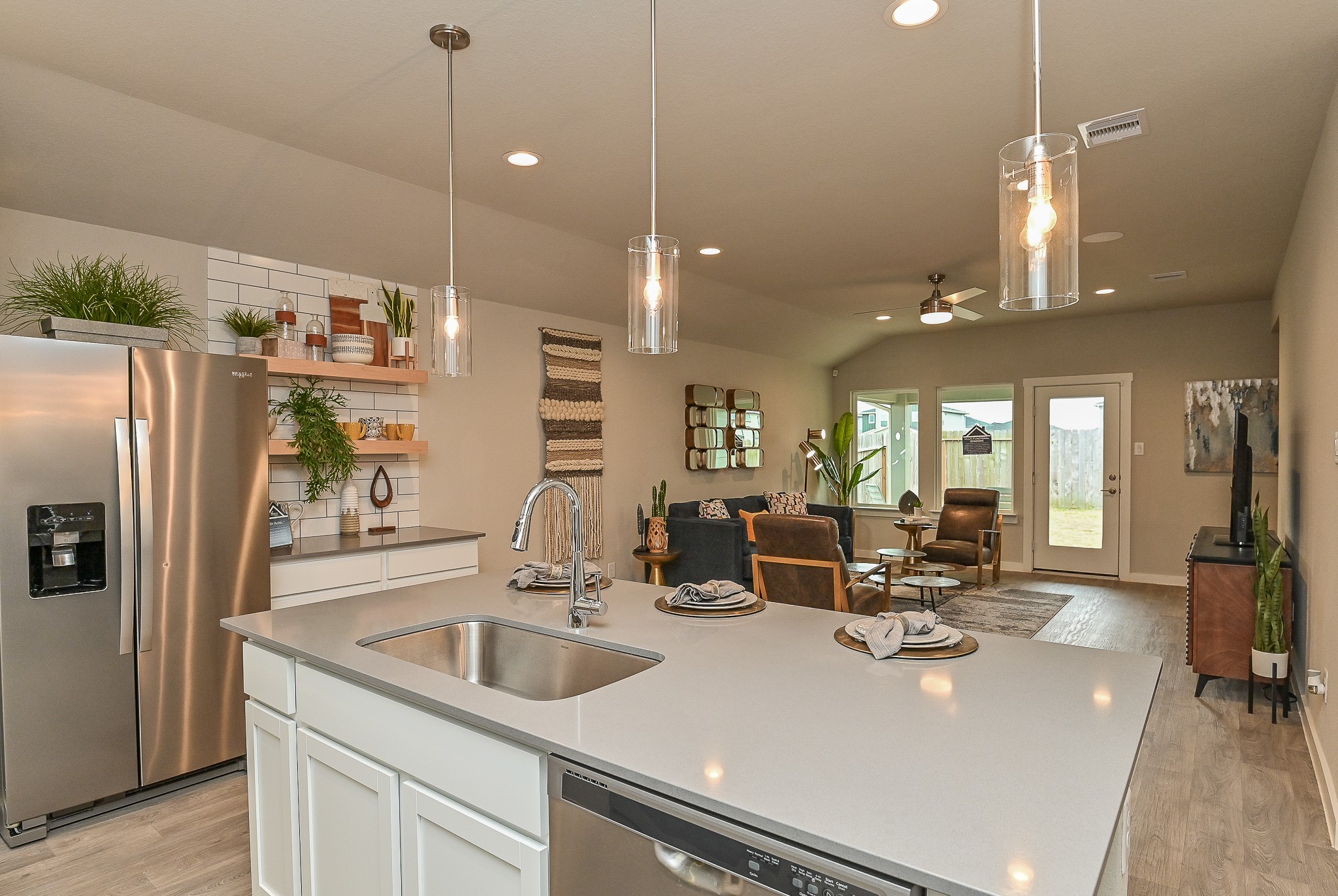 View from the kitchen into the living area; great lighting all around. ***Photo of furnished model***