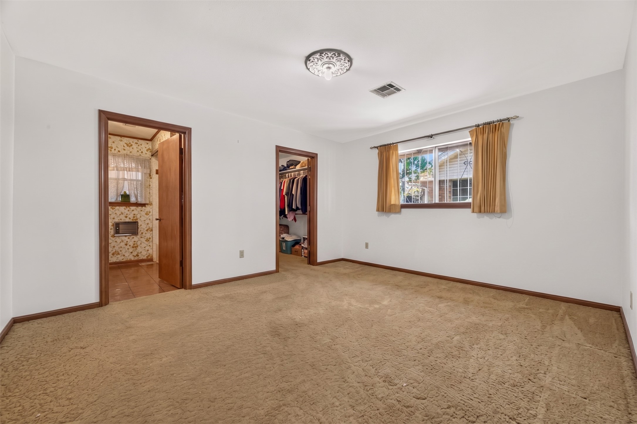 Primary bedroom with large walkin closet and fantastic bathroom space for the age of the home.