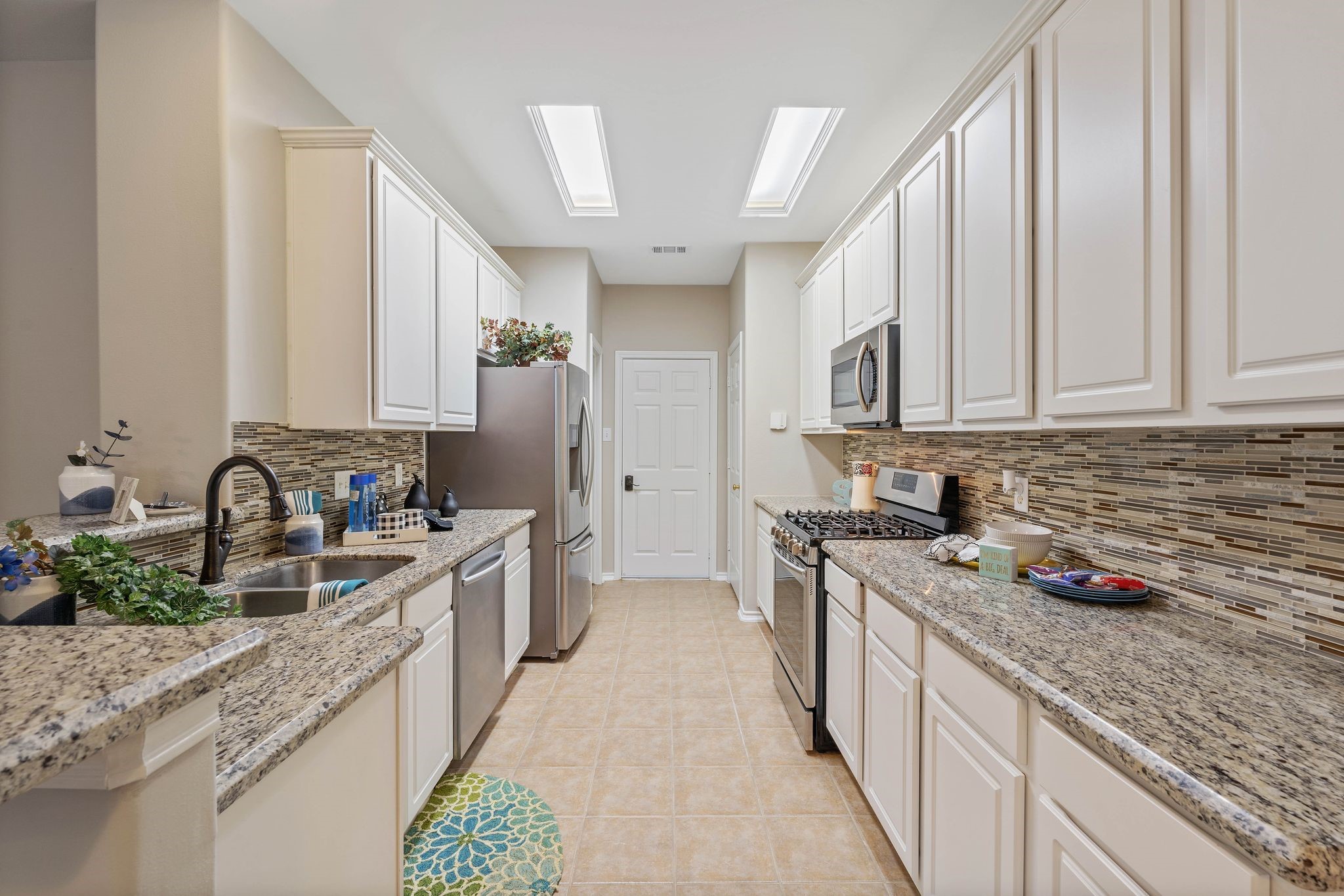 upgraded granite and stainless kitchen, appliance included, walk-in pantry, exit to your 2-car detached garage, gas cooktop, open concept to living area