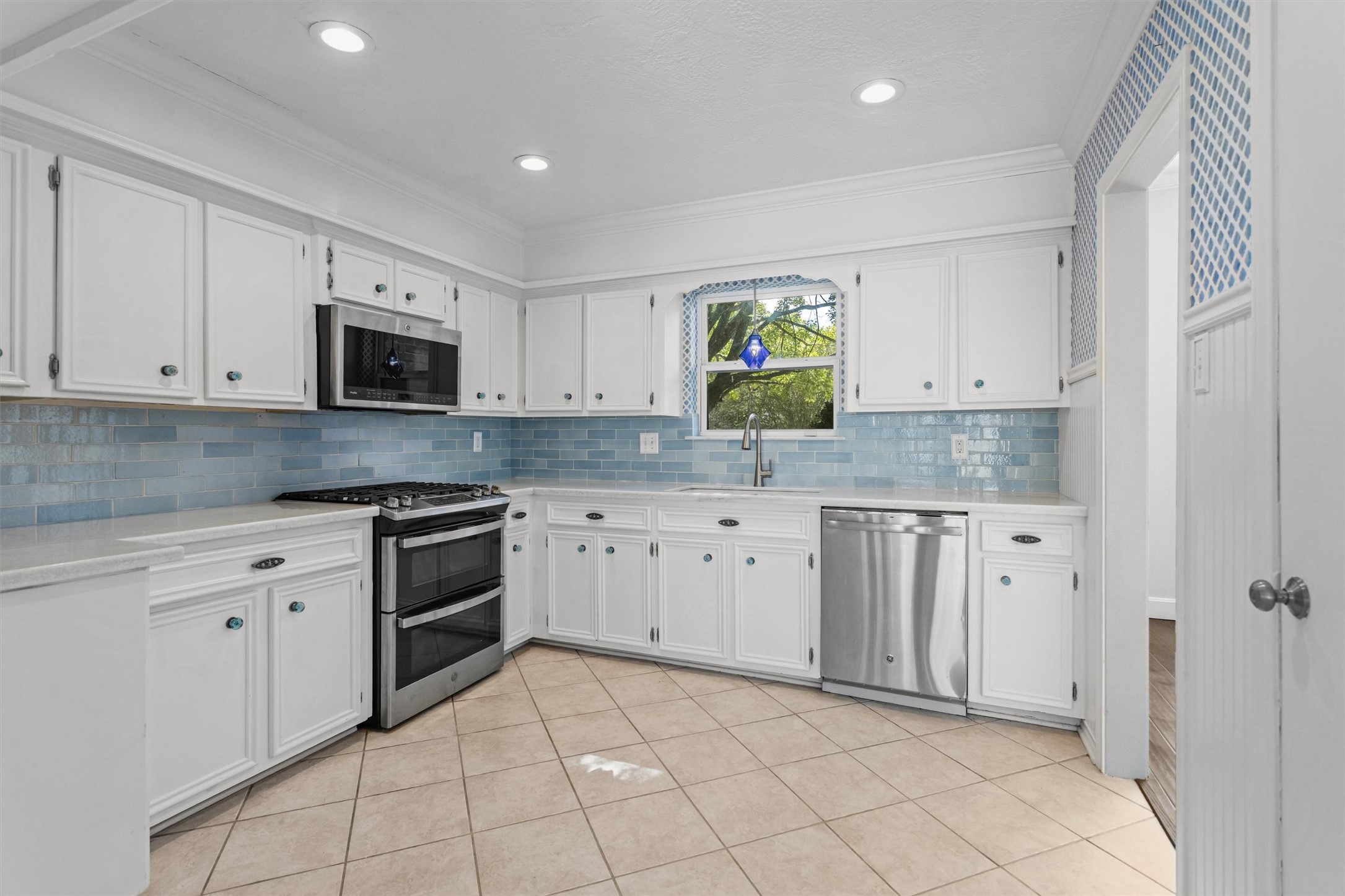 Kitchen with Quartz Counters and Tile Backsplash