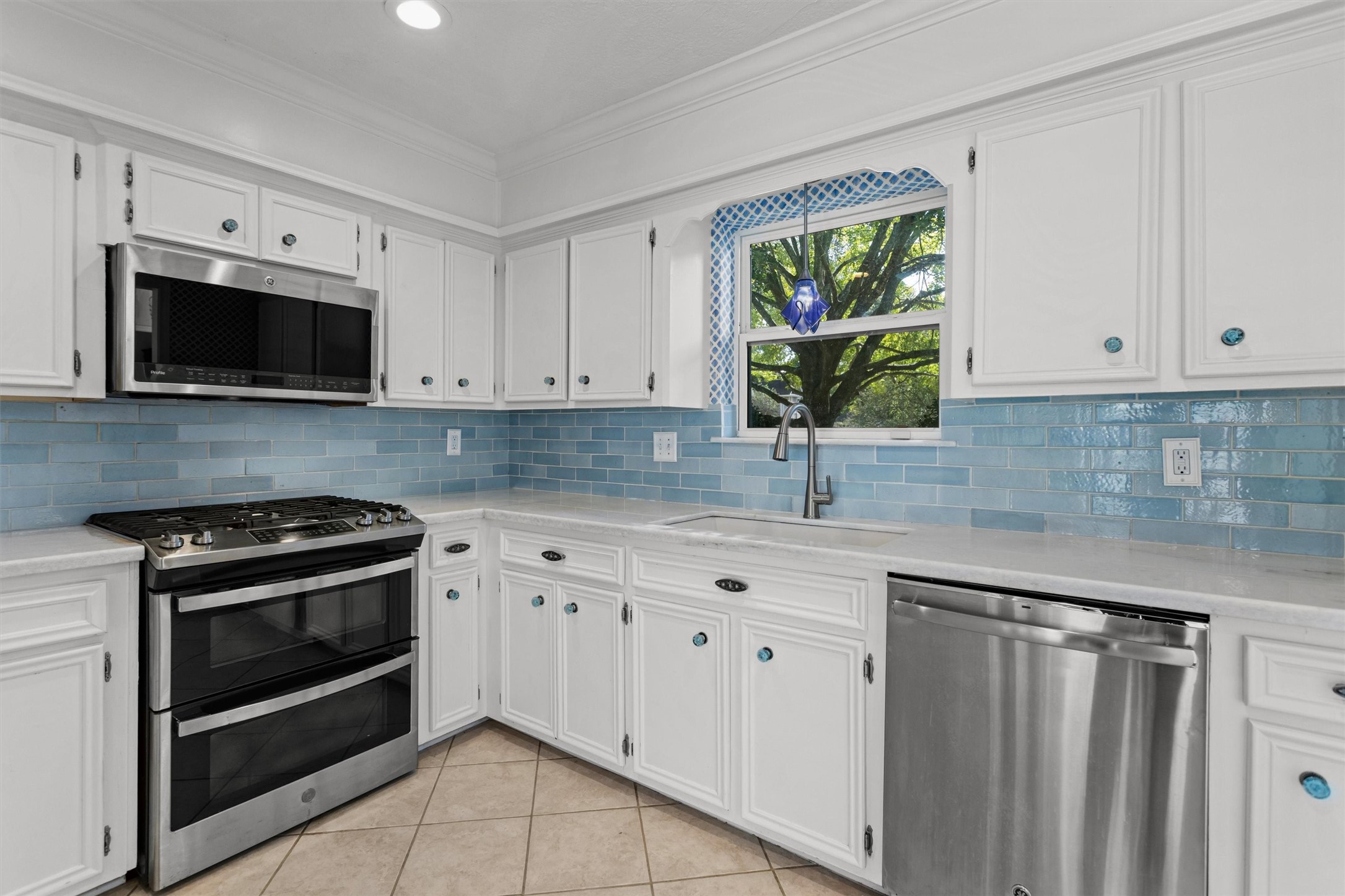 Kitchen with Quartz Counters and Tile Backsplash