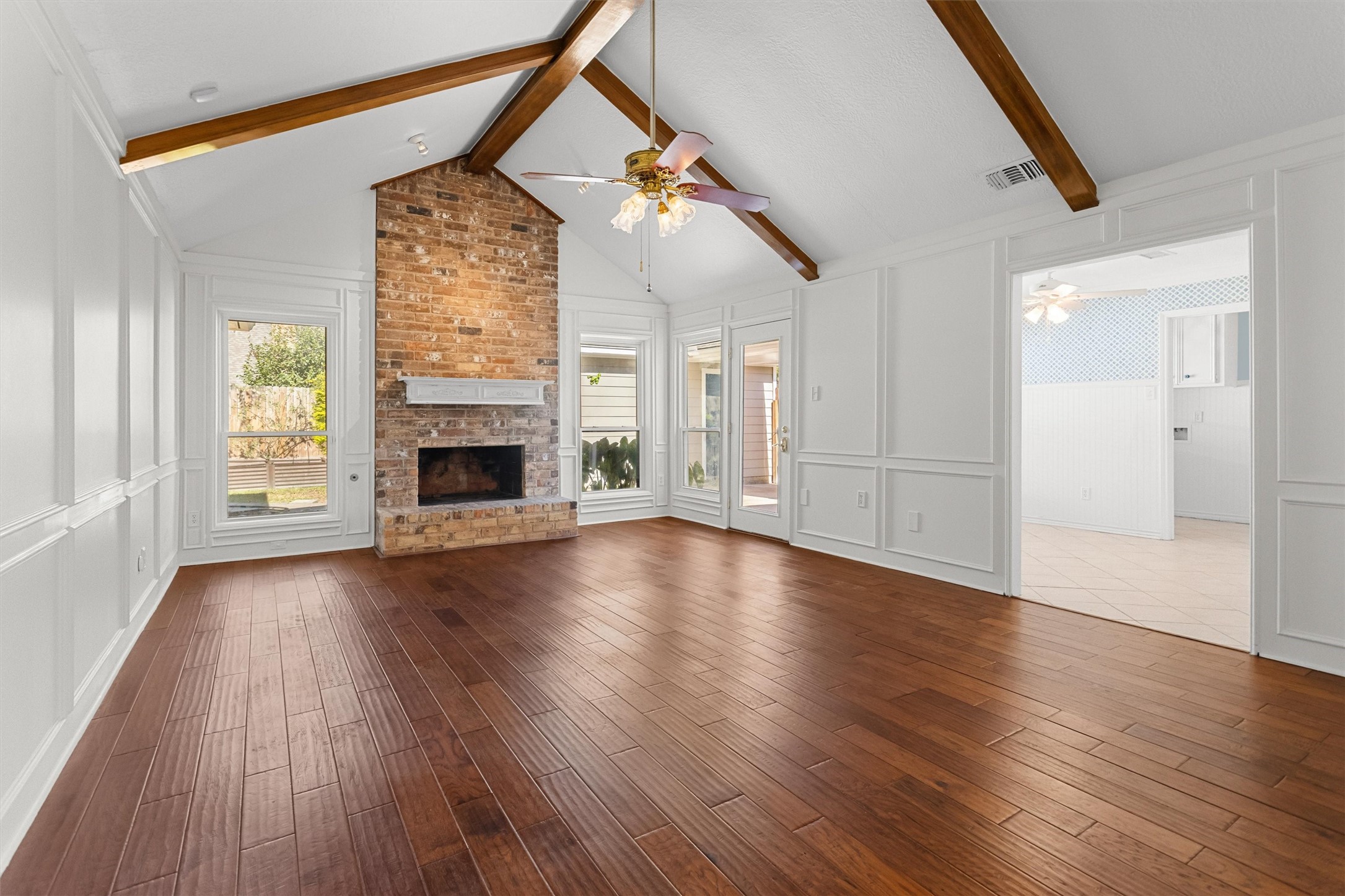 Den with Fireplace and Vaulted Ceiling.