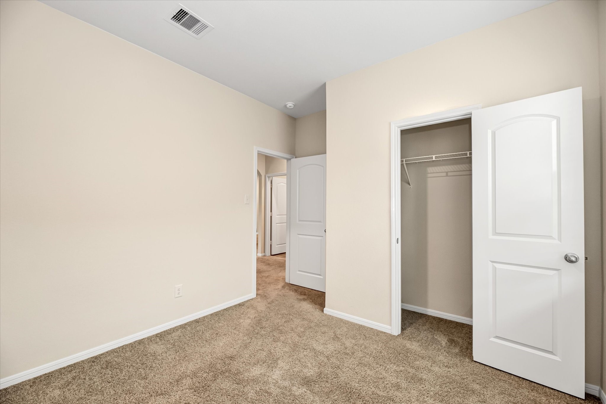 One of the two Secondary bedrooms with closet.