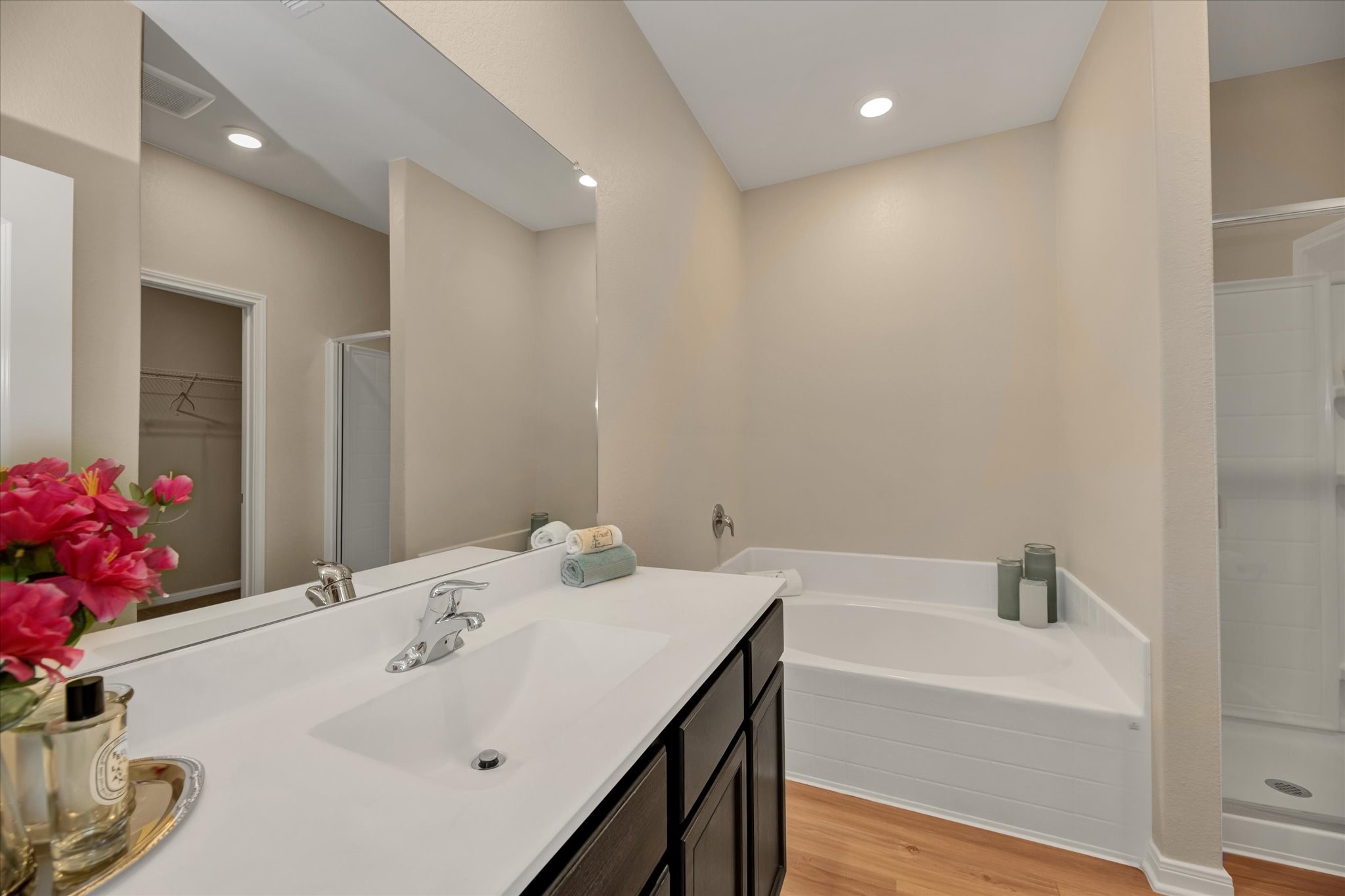 Primary bathroom with separate shower and soaking tub. Staged.