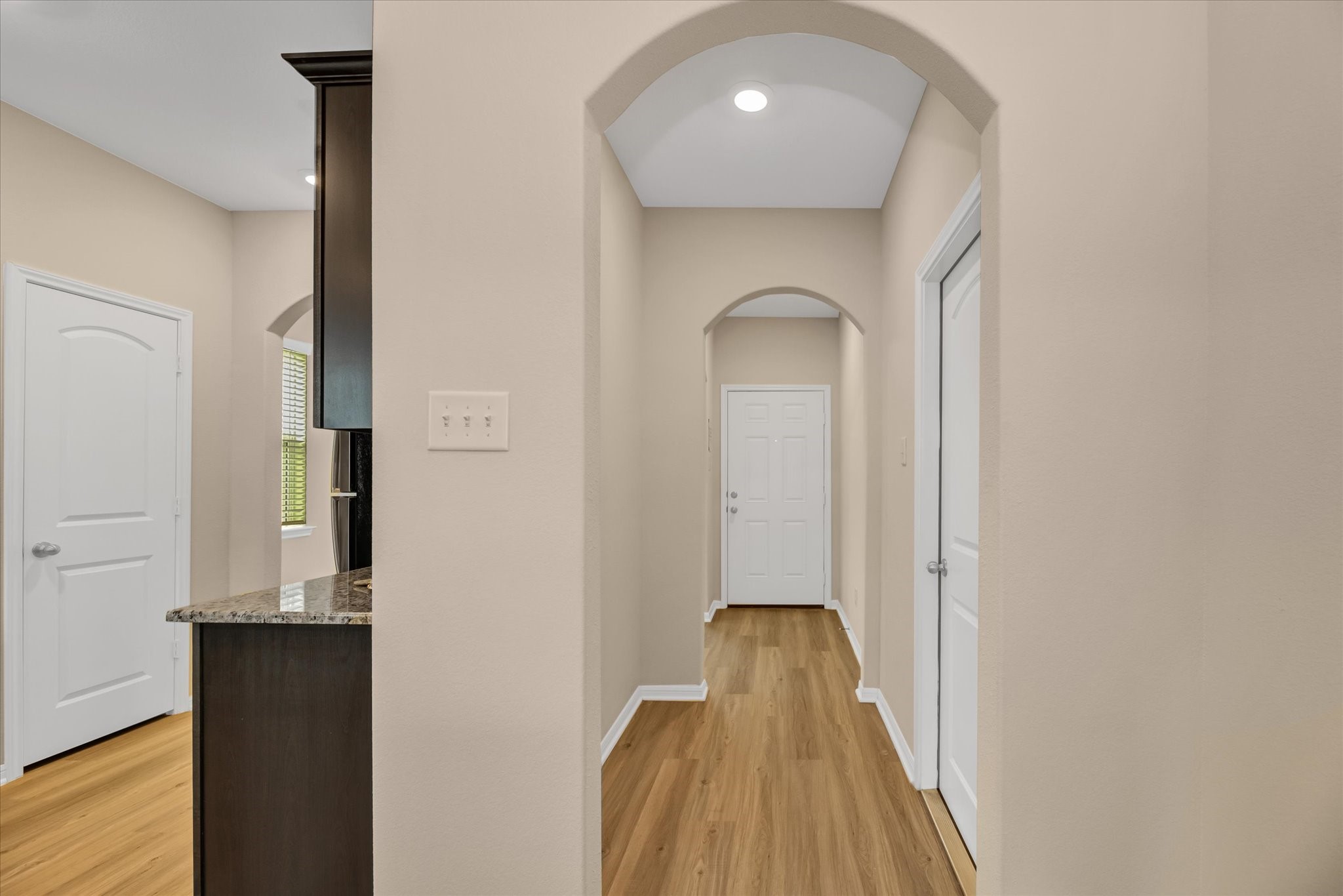 Foyer that connects with dining room, kitchen and garage access.
