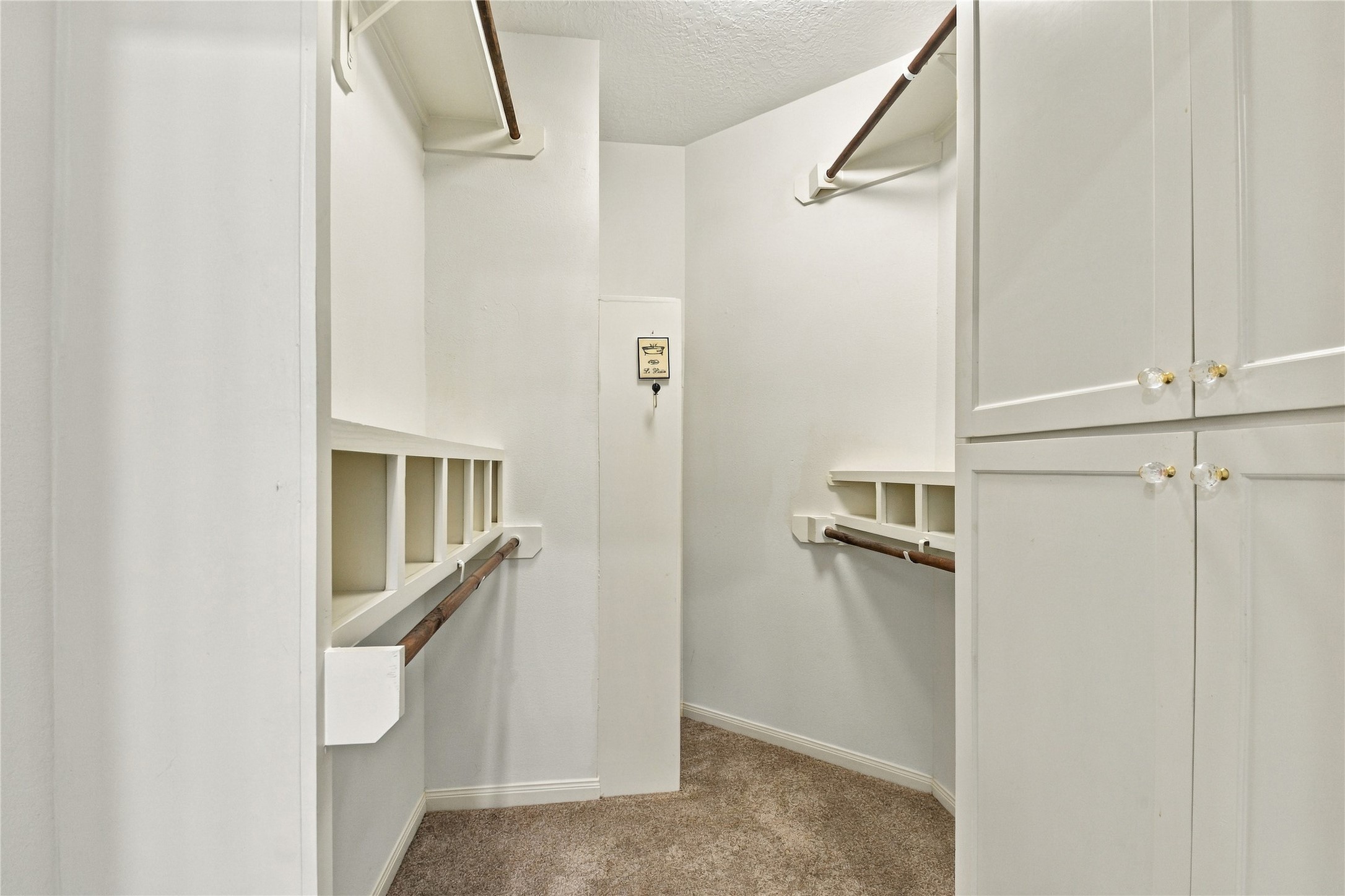 Custom closet in primary bathroom; one of two closets