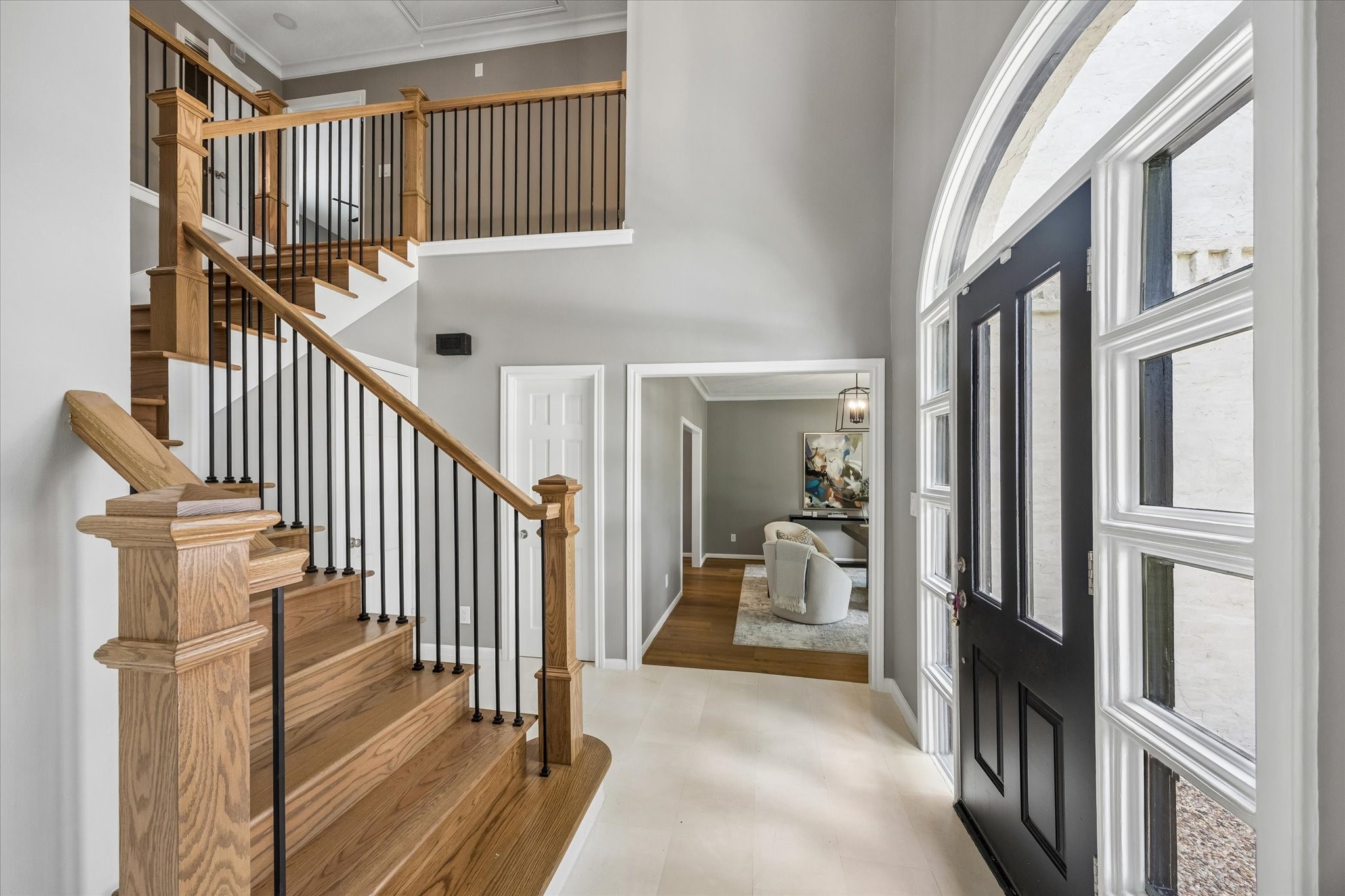 Stunning entryway with custom staircase, new entry tile and all new paint!