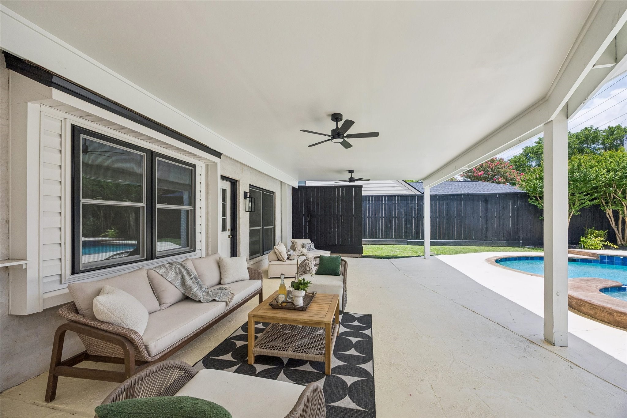 Dropped ceiling  for the addition of 3 outdoor fans! All new exterior paint -  updated painted stone for a sleek, peaceful backyard look!