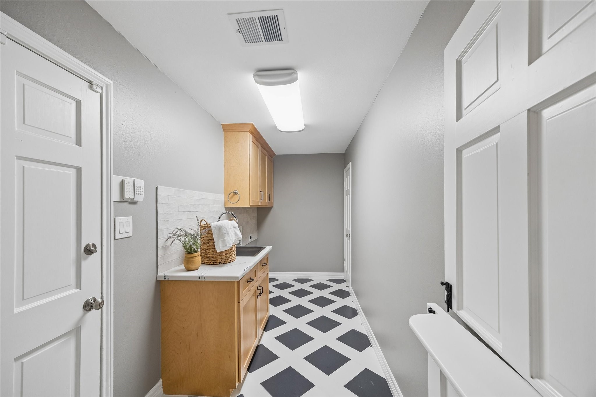 MASSIVE Laundry room with extra SINK!  Also in the back there is a secondary half bathroom.