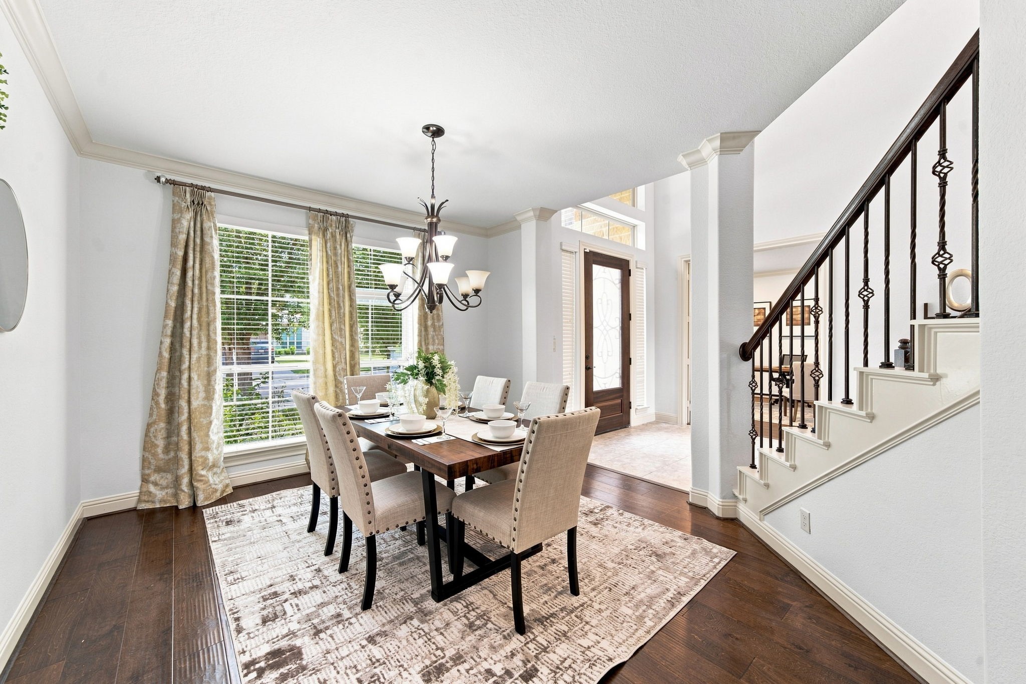 Elegant dining space filled with natural sunlight and warm hardwood floors throughout. Elegant dining space filled with natural sunlight and warm hardwood floors throughout.