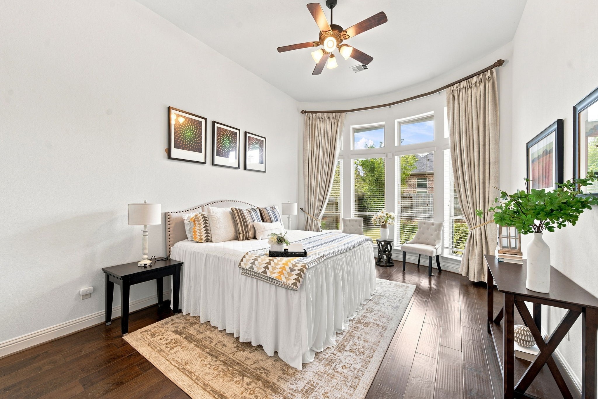 Welcome to your own private and spacious retreat with a curved wall of windows, a cozy sitting nook, and rich wood flooring throughout.