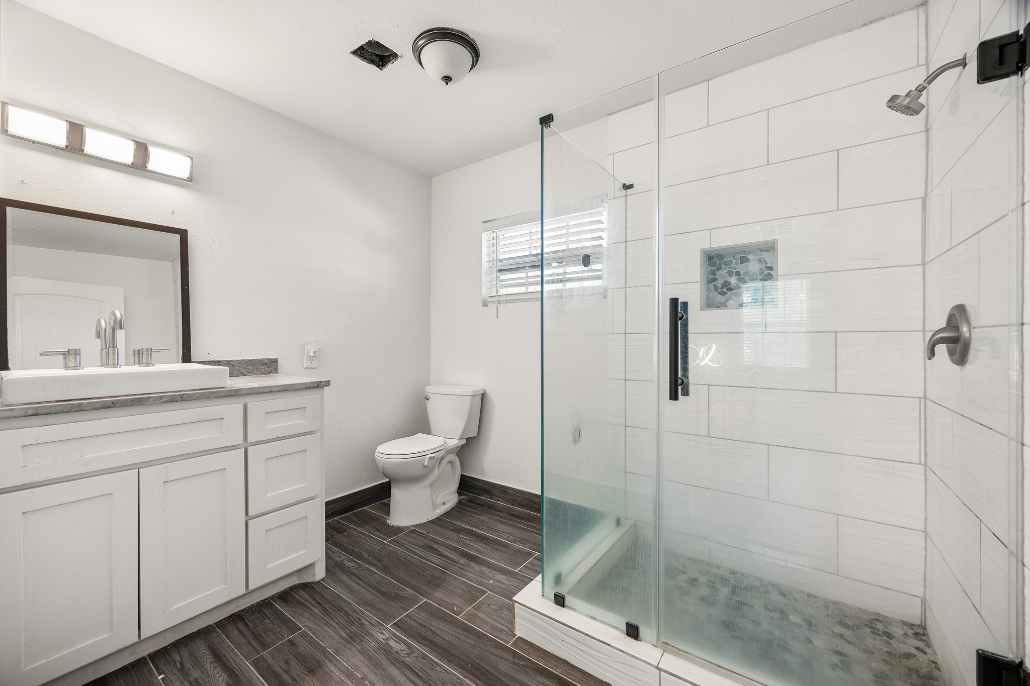 Bath #3 - offers a frameless en-closed walk-in shower.