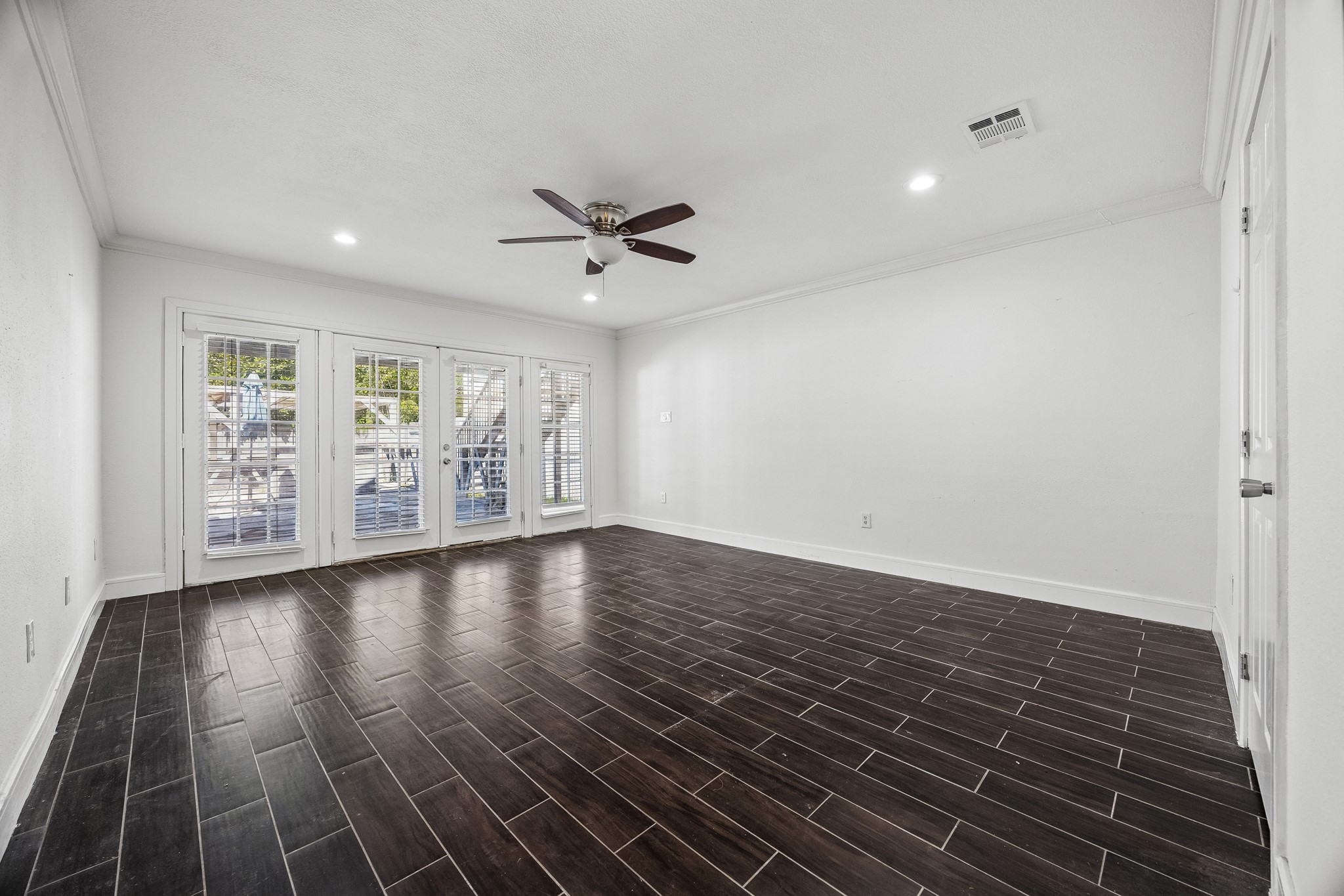 Primary bedroom on the first floor. Offers double French doors to the backyard.