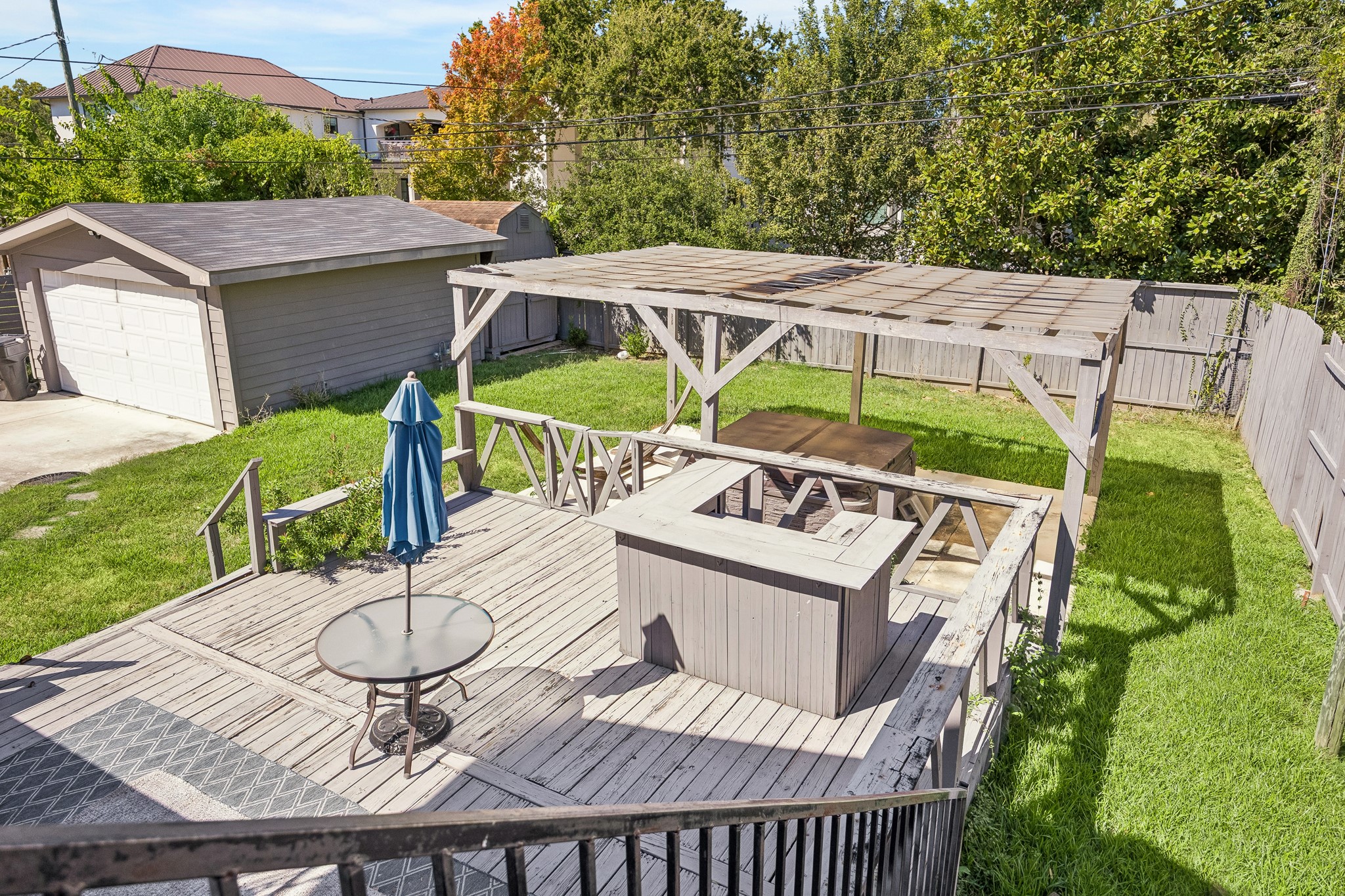 Backyard deck with seating area and pergola.