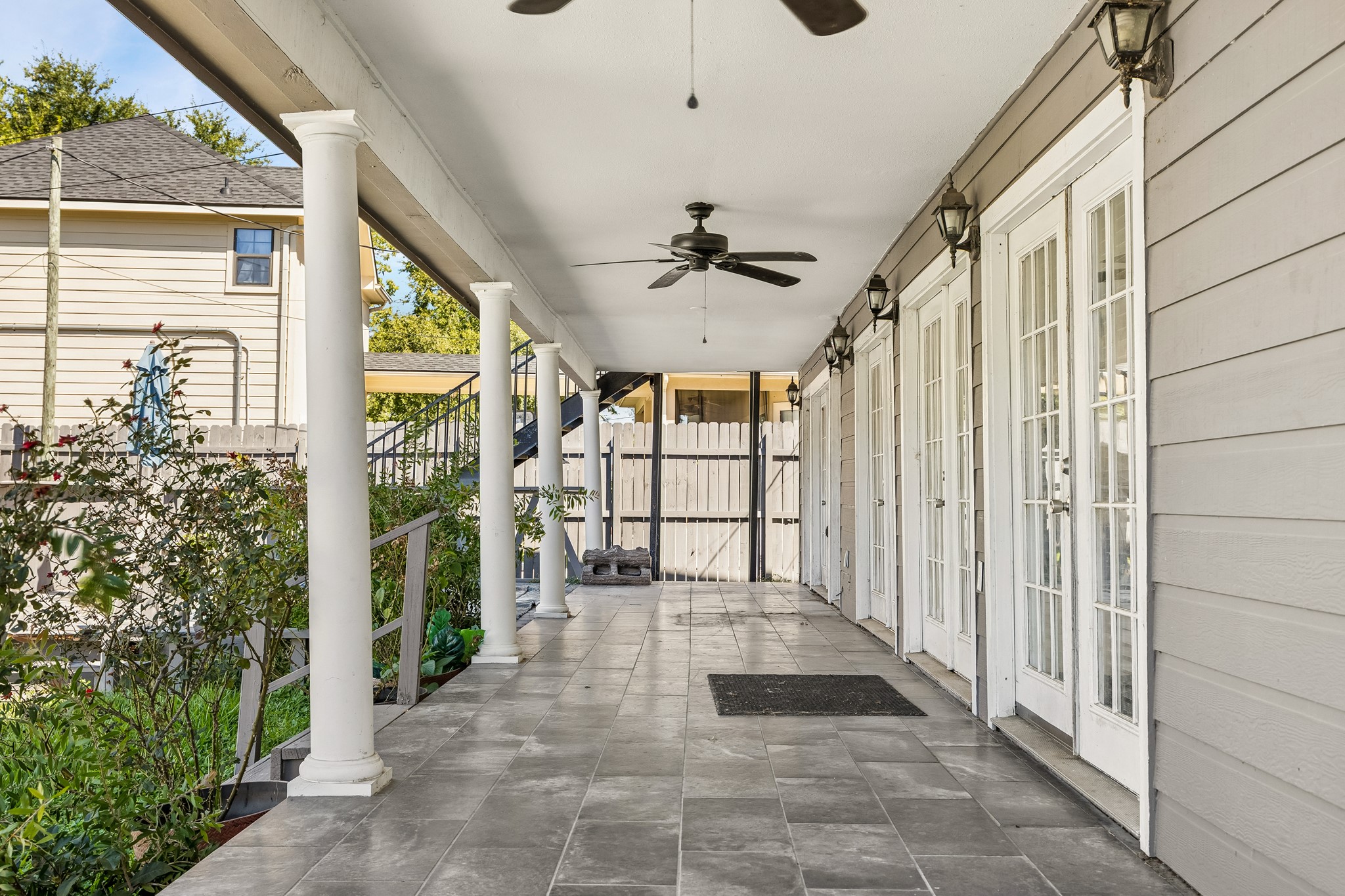 Covered patio with ceiling fan.