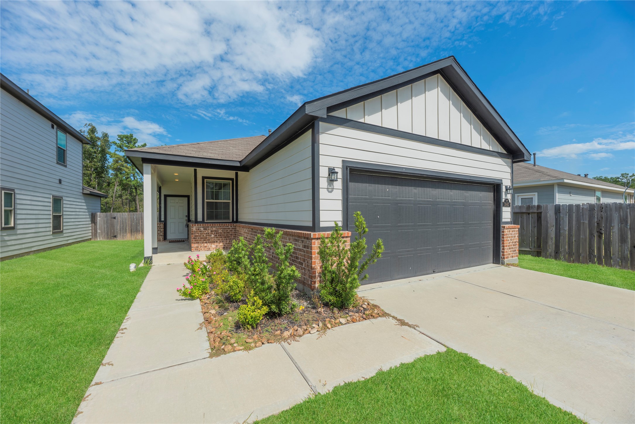 The sheltered entry offers a comfortable spot to arrive home, while contrasting trim and brick accents add character to the front exterior.
