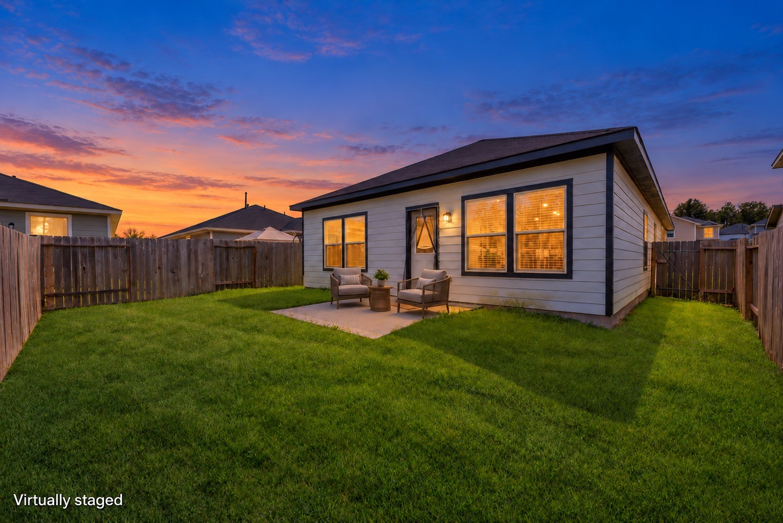 Imagine winding down on the patio with a pair of comfortable chairs overlooking the fenced lawn. Outdoor furniture is virtually staged and twilight lighting is digitally enhanced; daytime original included.