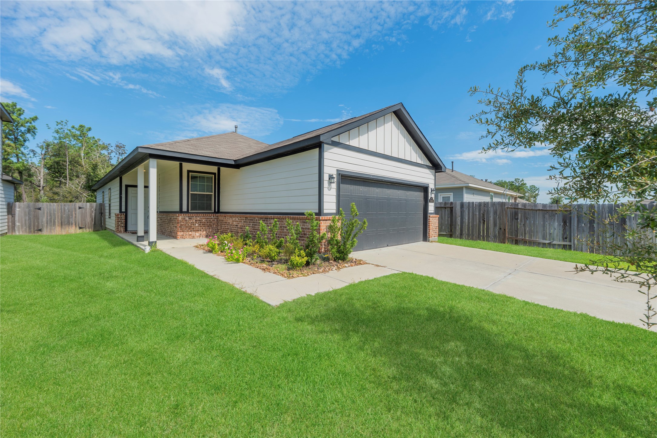 A covered front entry, crisp siding and brick accents give this single-story home a welcoming first impression, with an attached garage and a driveway that leads right to your door.
