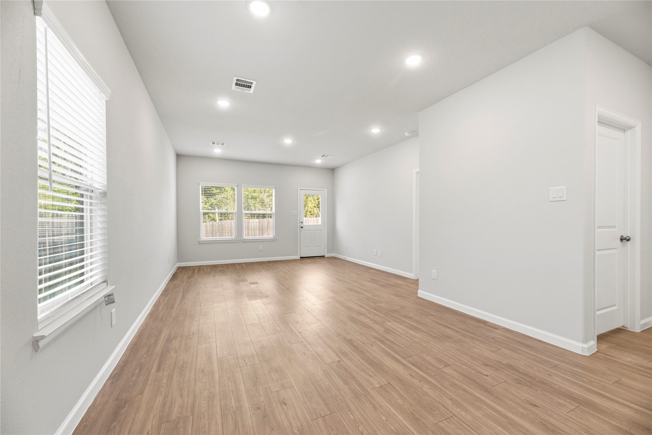 Windows along two walls bring daylight into the living area, while neutral finishes offer a flexible backdrop for your furniture and personal style.